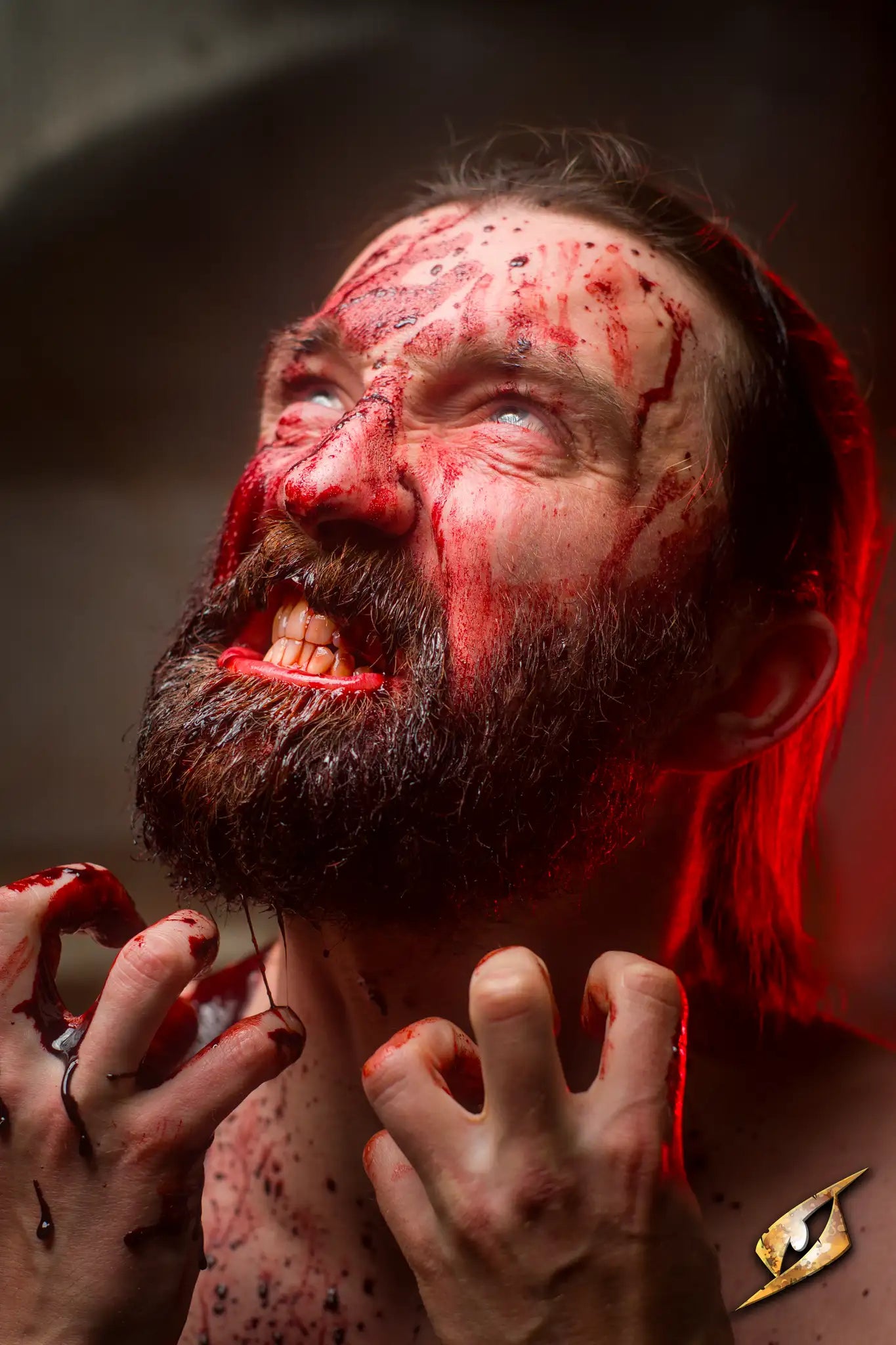 Halloween themed horror image of a man covered in blood with an intense expression.