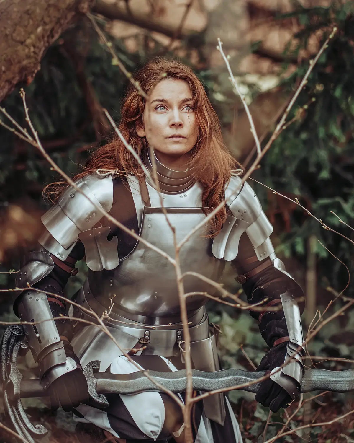 A woman in armor with long hair, immersed in nature, evoking a sense of adventure in Knight Time.