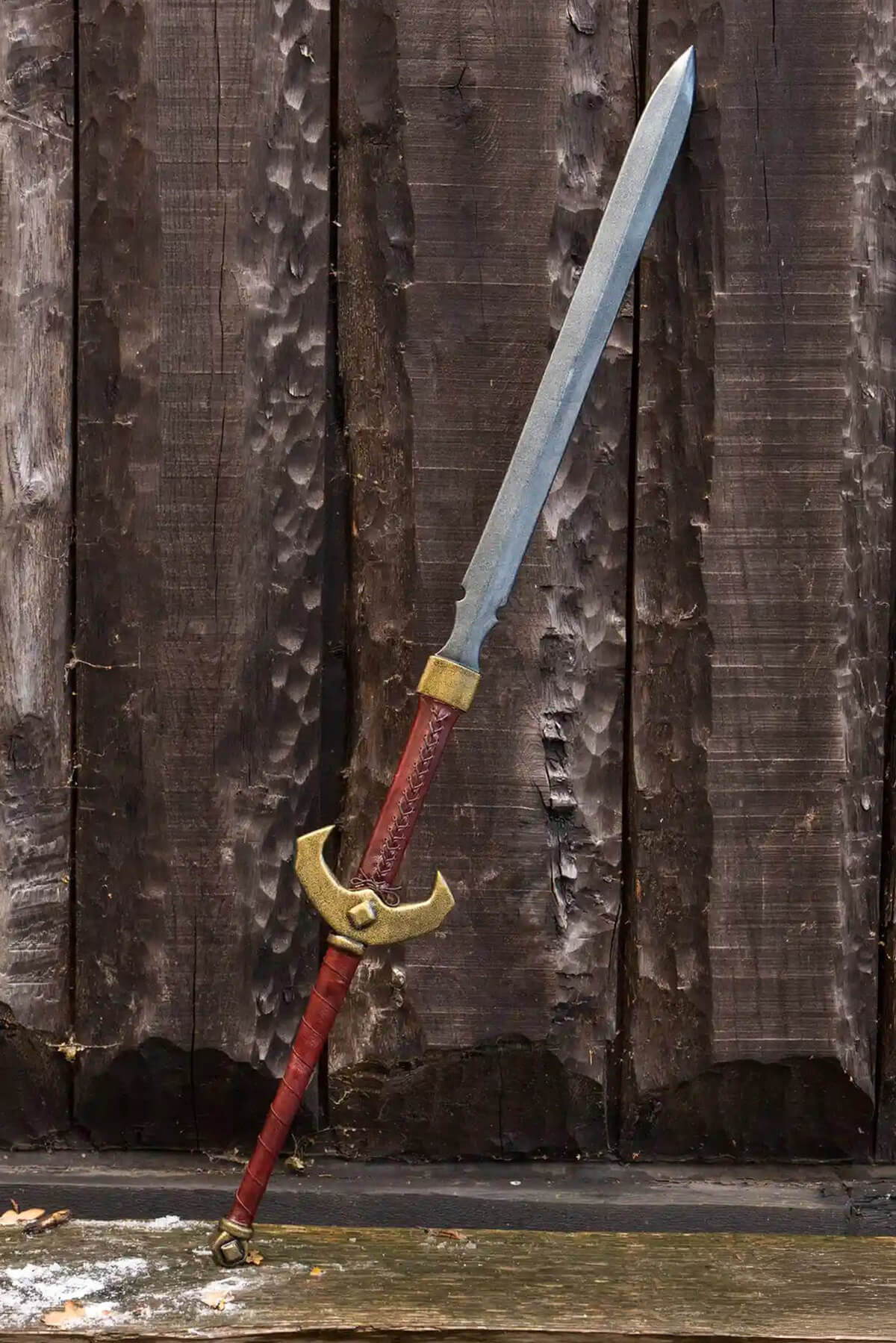 Two-Handed Swords displayed against a wooden backdrop, showcasing its bold design and intricate details.
