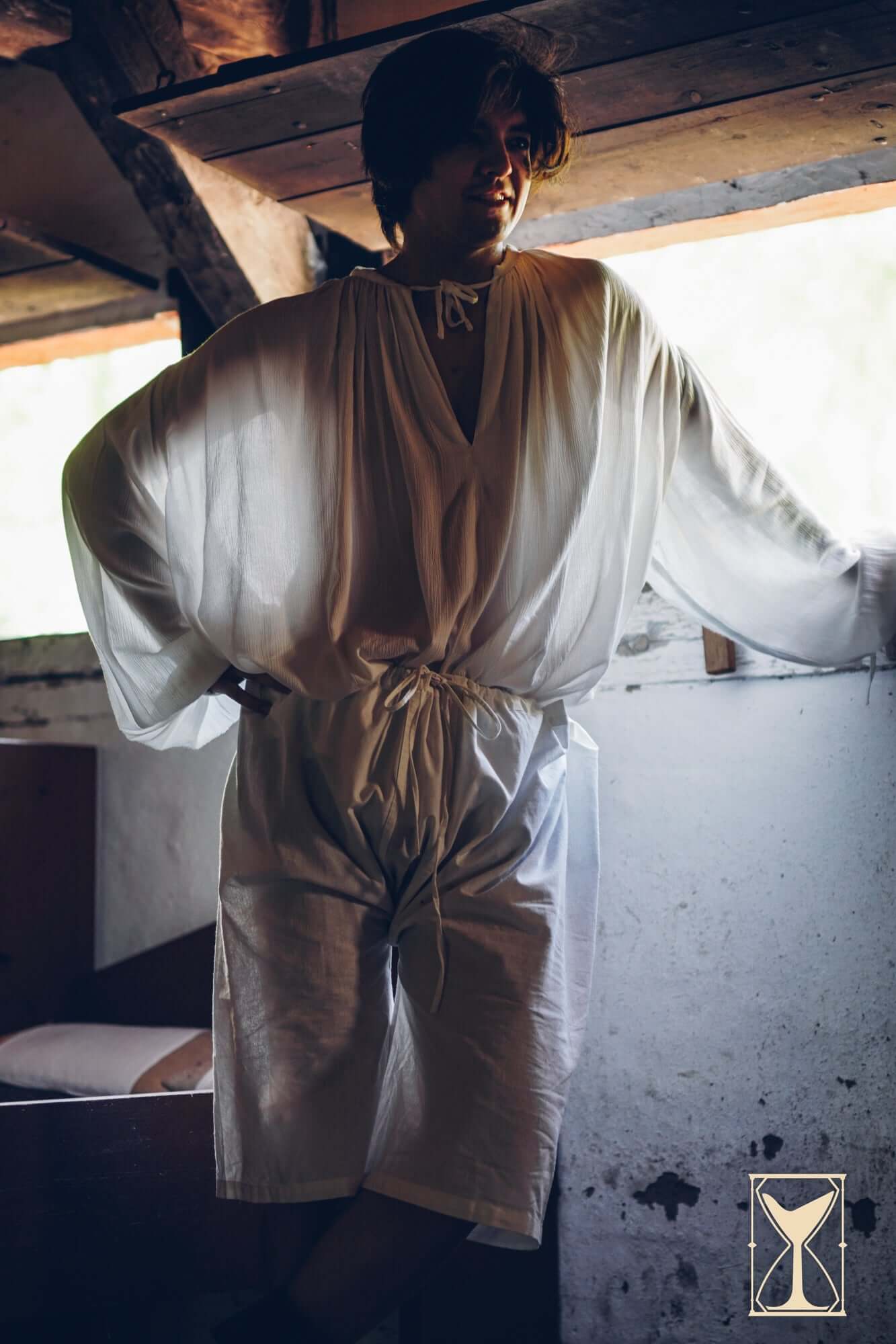 Model wearing medieval undergarments in a cozy setting - Medieval Undergarments - Yoremade.