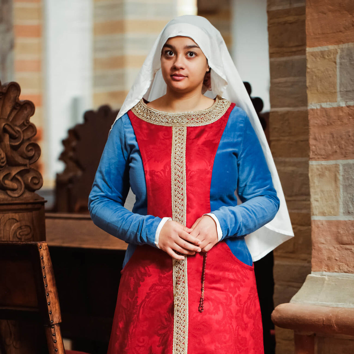 Late Medieval Period Clothing - Yoremade showcasing a woman in a red and blue gown with a white veil.