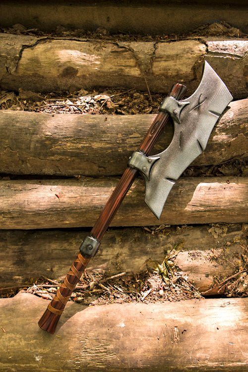 Axes displayed on wooden logs, showcasing the powerful design ideal for LARP and medieval battles.