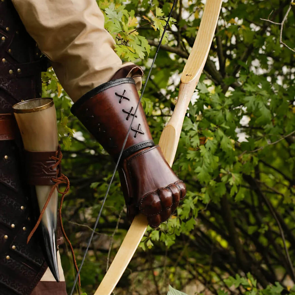 A medieval archer in leather armor holding a wooden bow, part of the Bows collection.