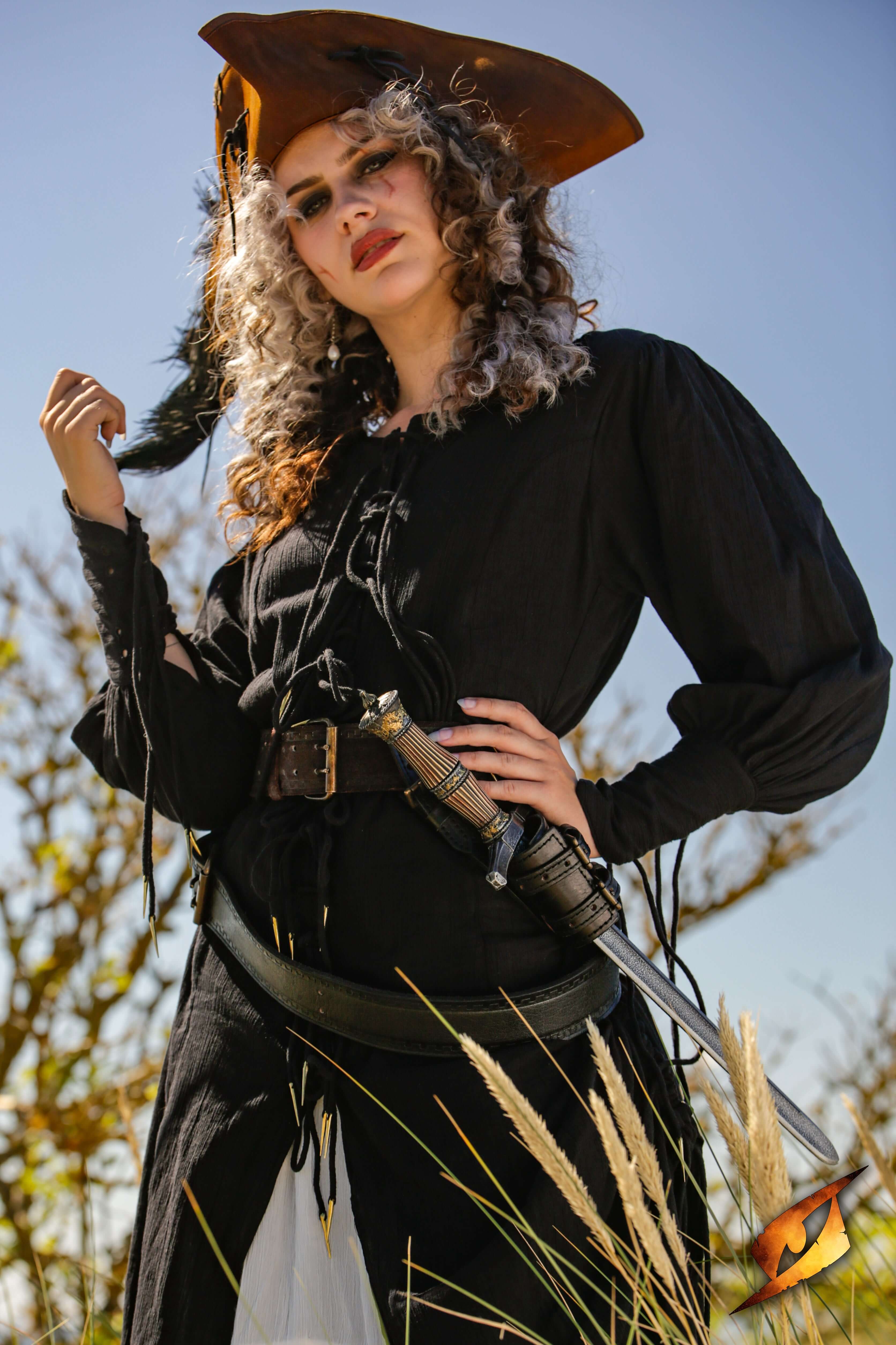 A fierce model dressed as a pirate in black attire, showcasing a Blocking Dagger at her side, ready for action.