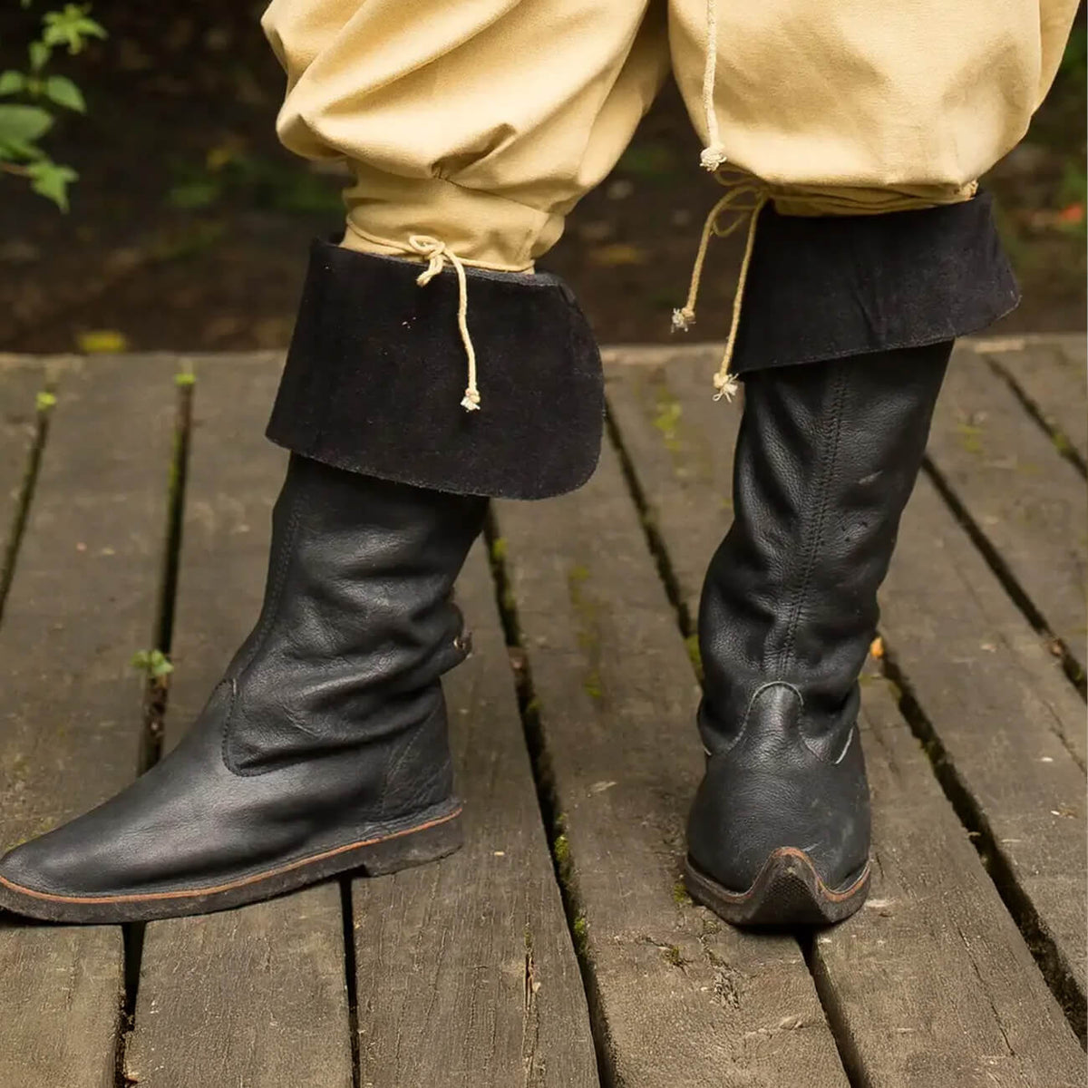 Close-up of black Pirate Boots with folded cuffs, perfect for deck, dock, and festival ground adventures.