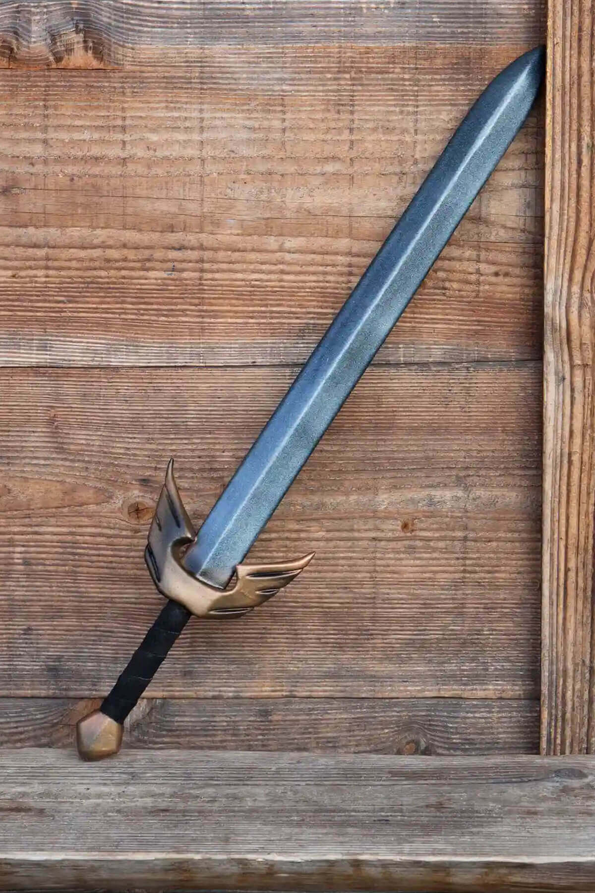 Ready For Battle Swords displayed against a wooden backdrop, showcasing a solid foam sword for LARPing.