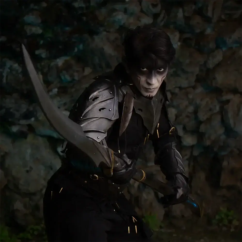 Warrior in dark armor wielding a curved sword, standing against a rocky background, exuding a mystical aura.