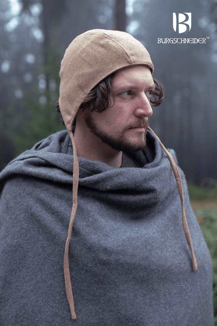 A man wearing a warm Wolfram Bundling Hood by Burgschneider, showcasing its medieval style and comfort.