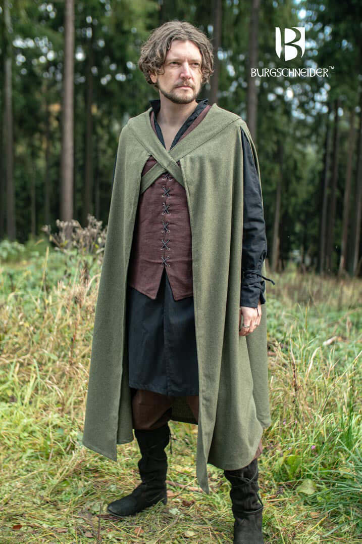 Cape Justus worn by a man in a woodland setting, showcasing the heavy wool blend design and chest-crossing bindings.
