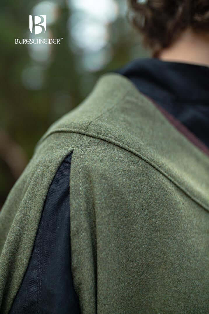 Close-up of the Cape Justus showcasing its shoulder design and fabric texture in a natural setting.