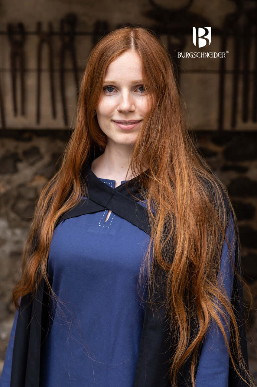 Young woman wearing Cape Morpheus, showcasing its lightweight design and stylish cross-bindings.