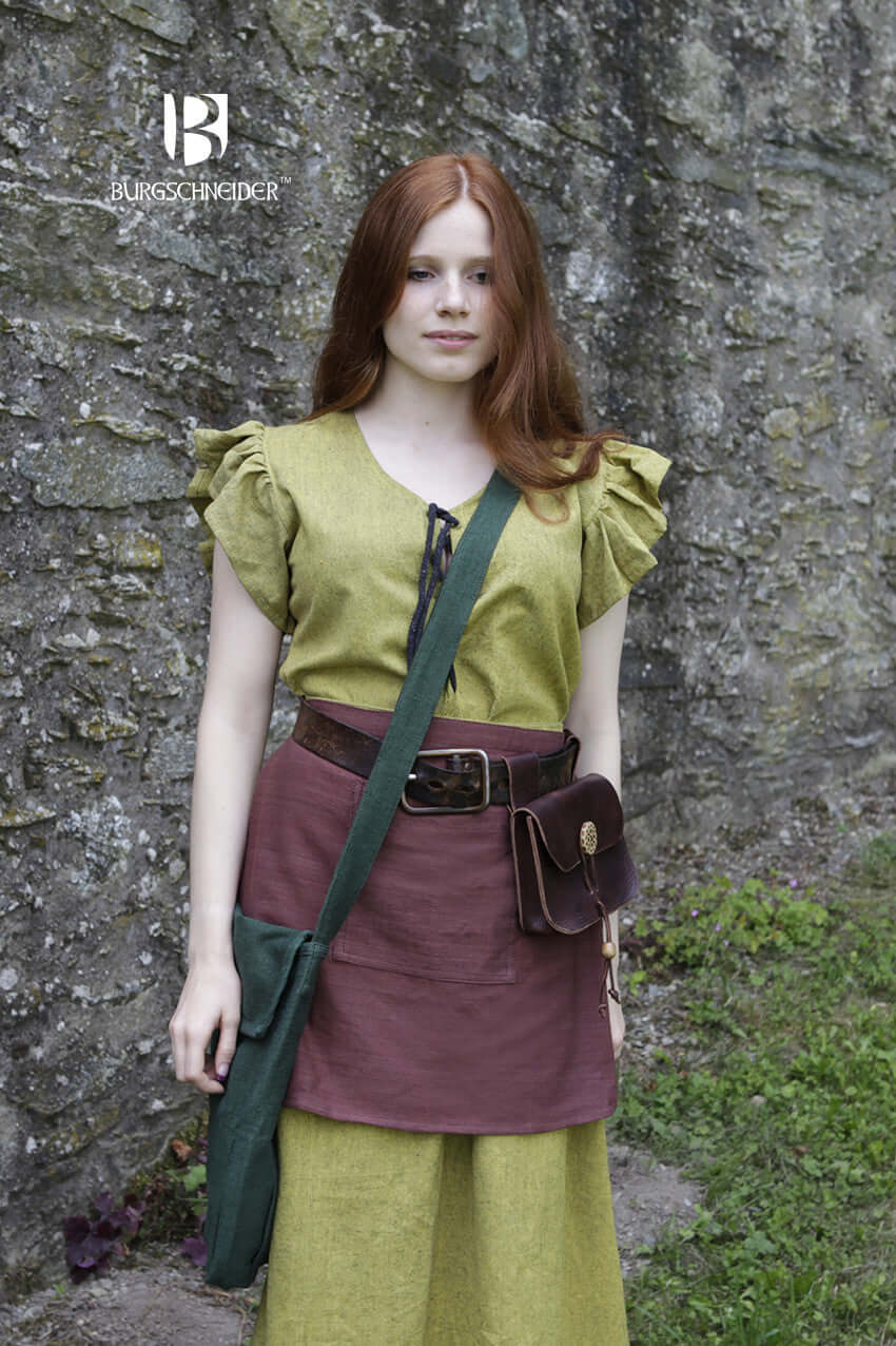 Young woman wearing Bag Ehwaz, a medieval-style bag, with authentic cotton fabric and strap.