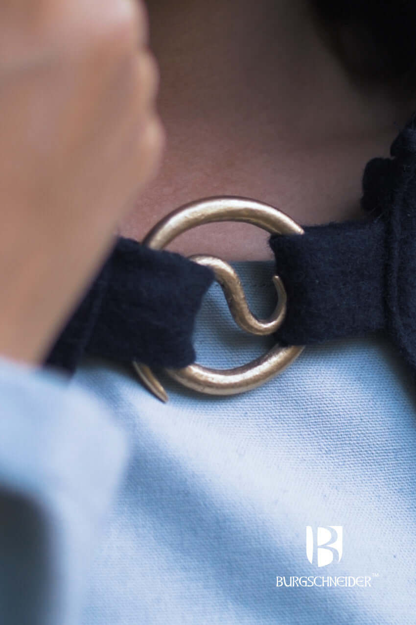 Brooch Spiral Brooch Lukk fastening a cloak with a spiral design, showcasing individual craftsmanship.