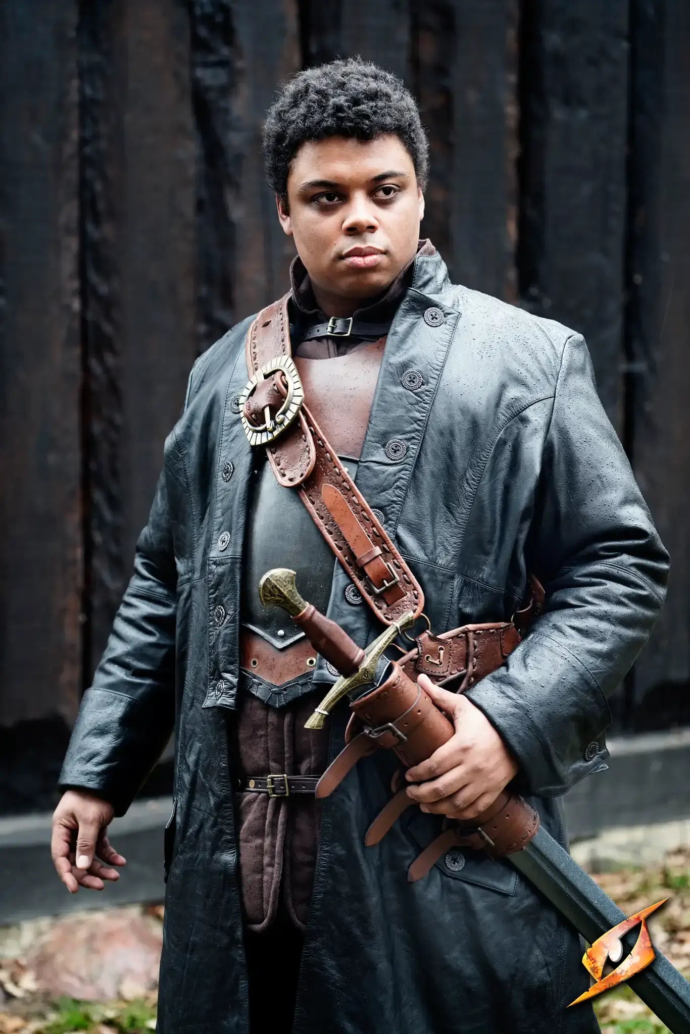 Model wearing a Coat Hellsing - Leather with a sword, showcasing a confident stance.