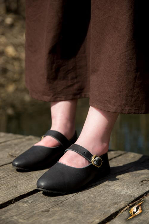 Shoes Astrid worn by a person on a wooden surface, showcasing classic style and comfortable design.