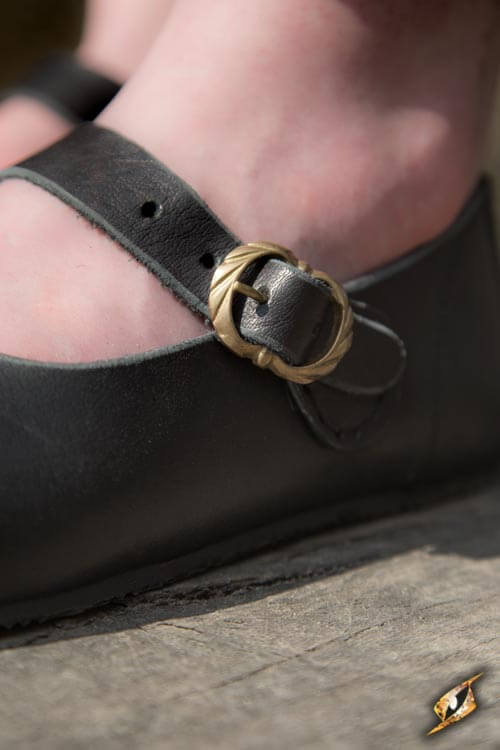 Close-up of Shoes Astrid showing leather strap and buckle detail on a woman's foot.