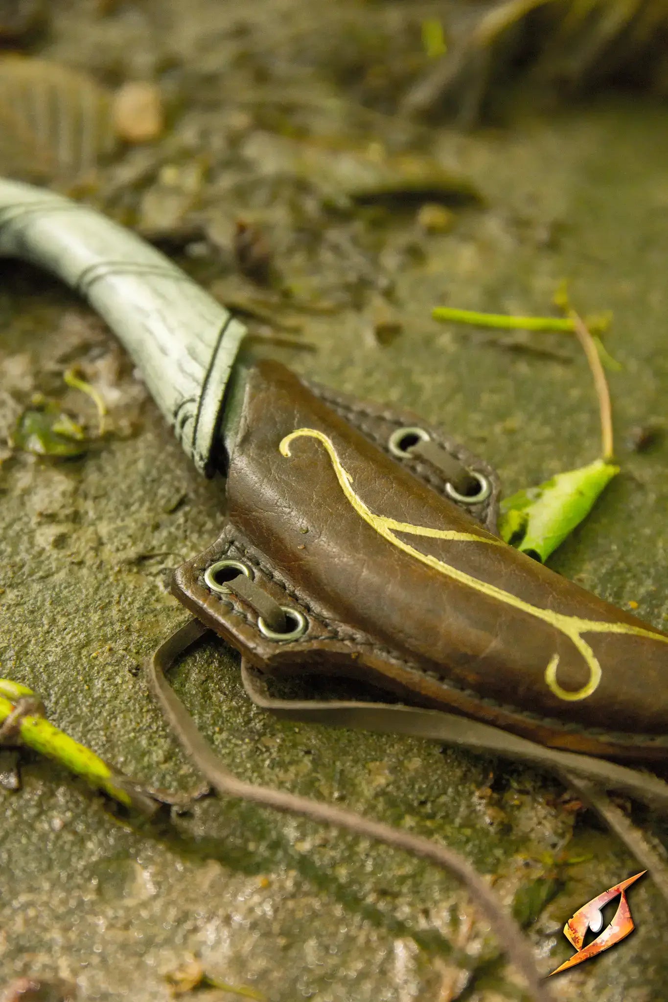 Elven Throwing Knife & Holder showcased on a forest floor with intricate detailing and natural elements.