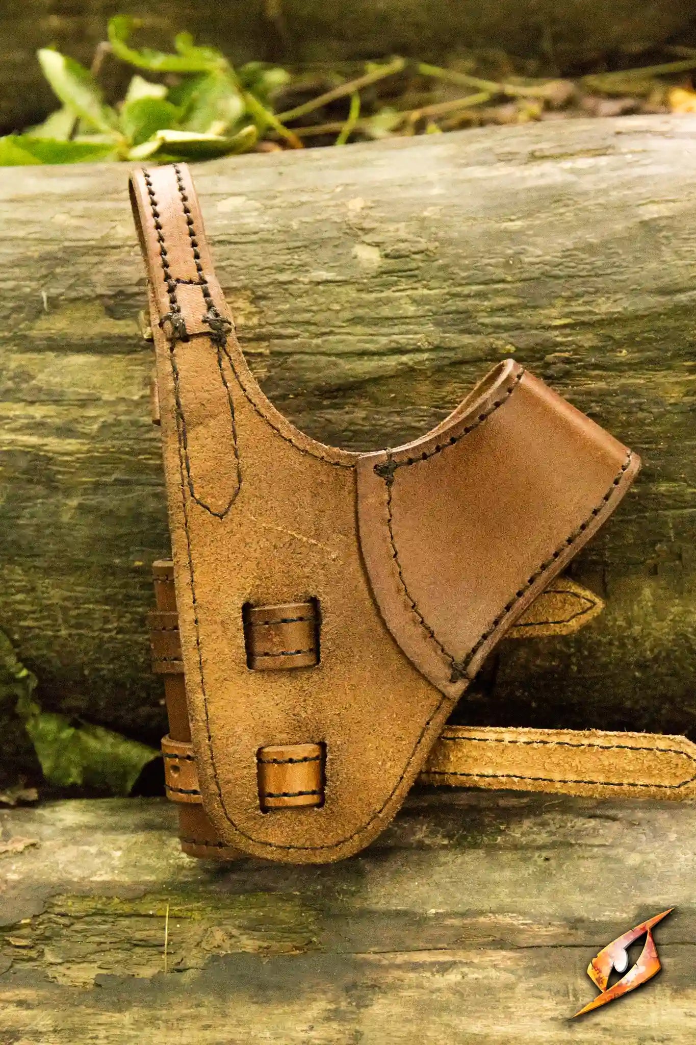 Adventurer Swordholder handcrafted leather accessory resting on logs, perfect for any adventurer's gear.