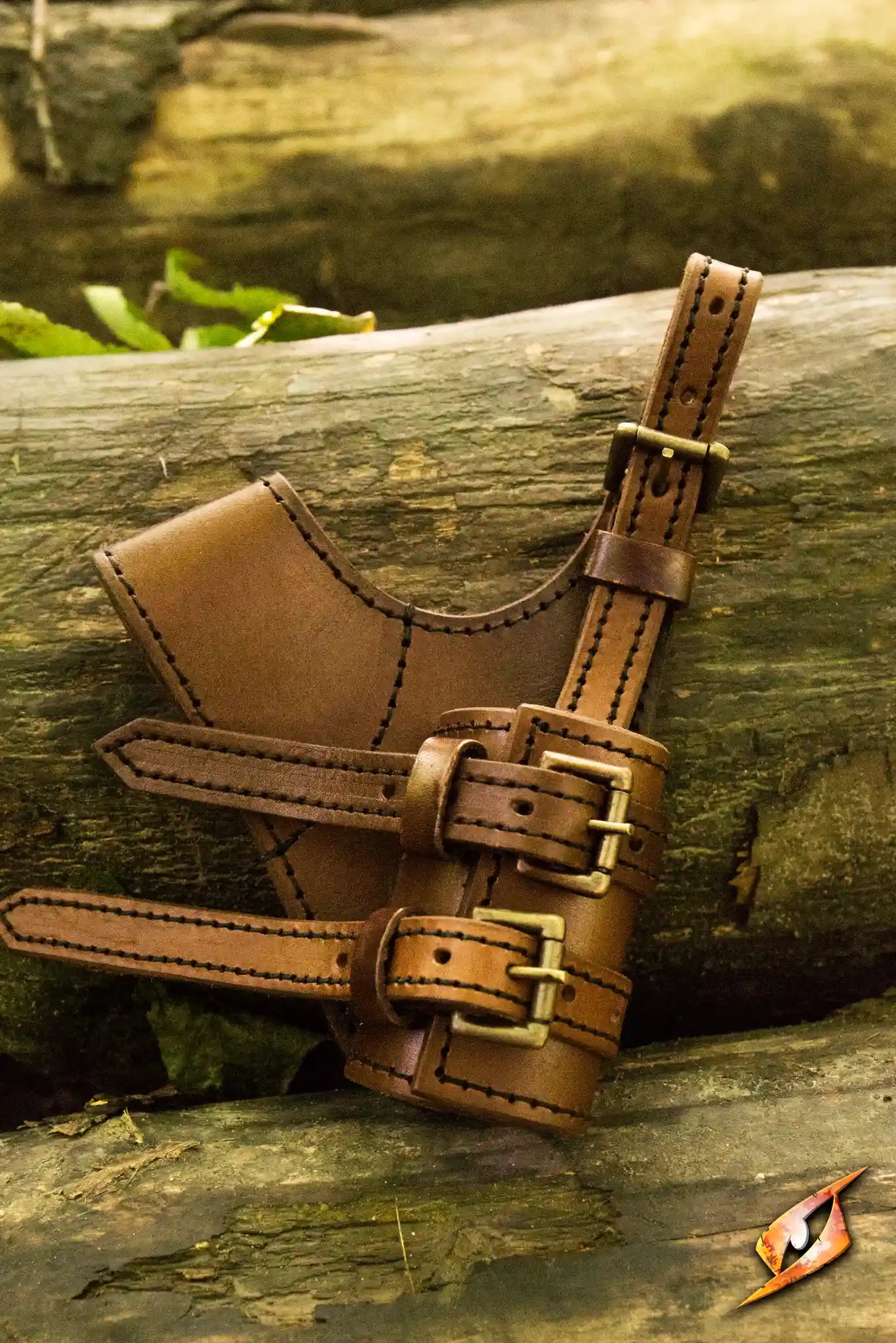Adventurer Swordholder shown on a log, highlighting its sleek leather design and adjustable straps.