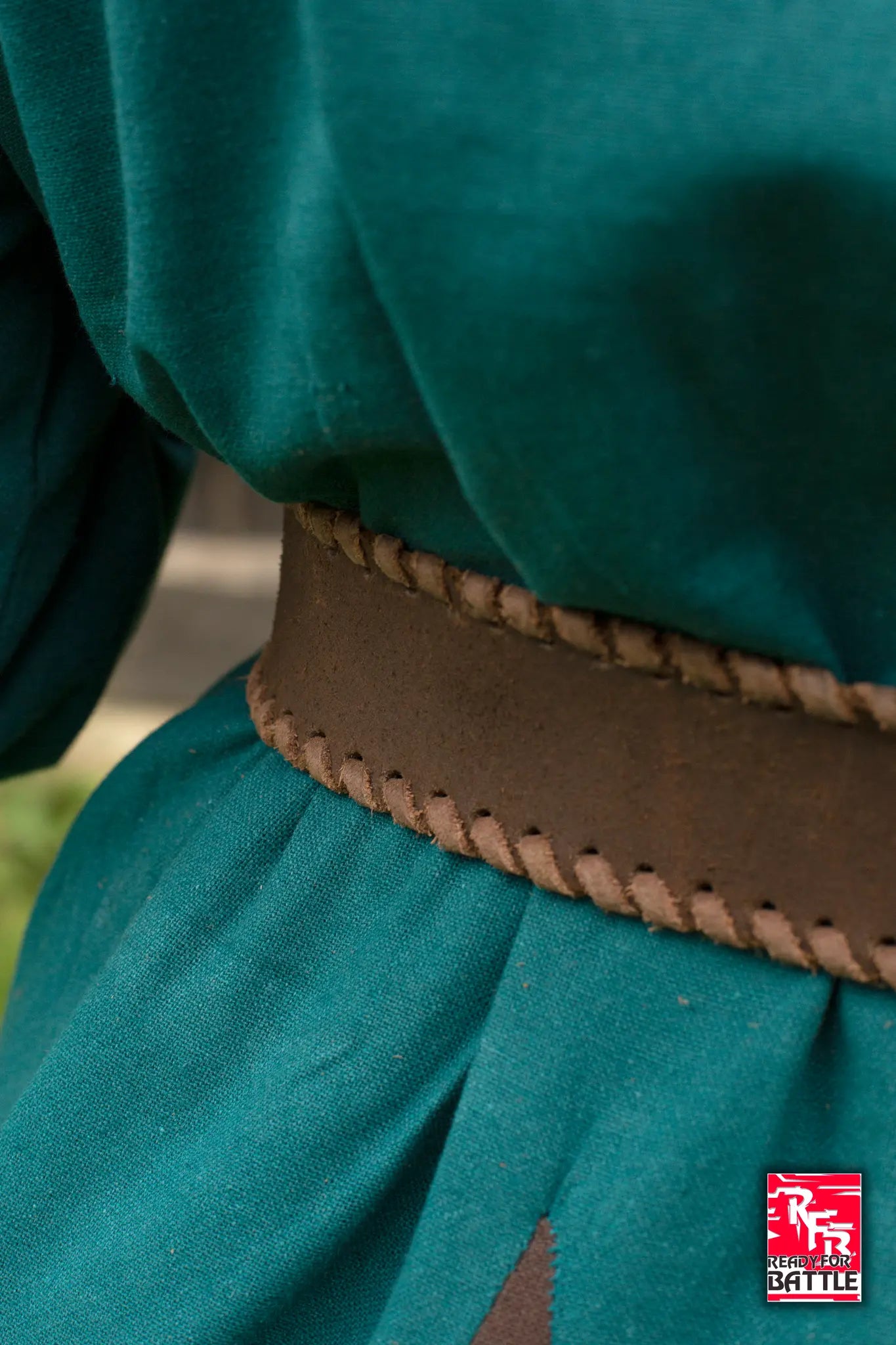 RFB Laced Belt worn with a green outfit, featuring a detailed braided design for added style.