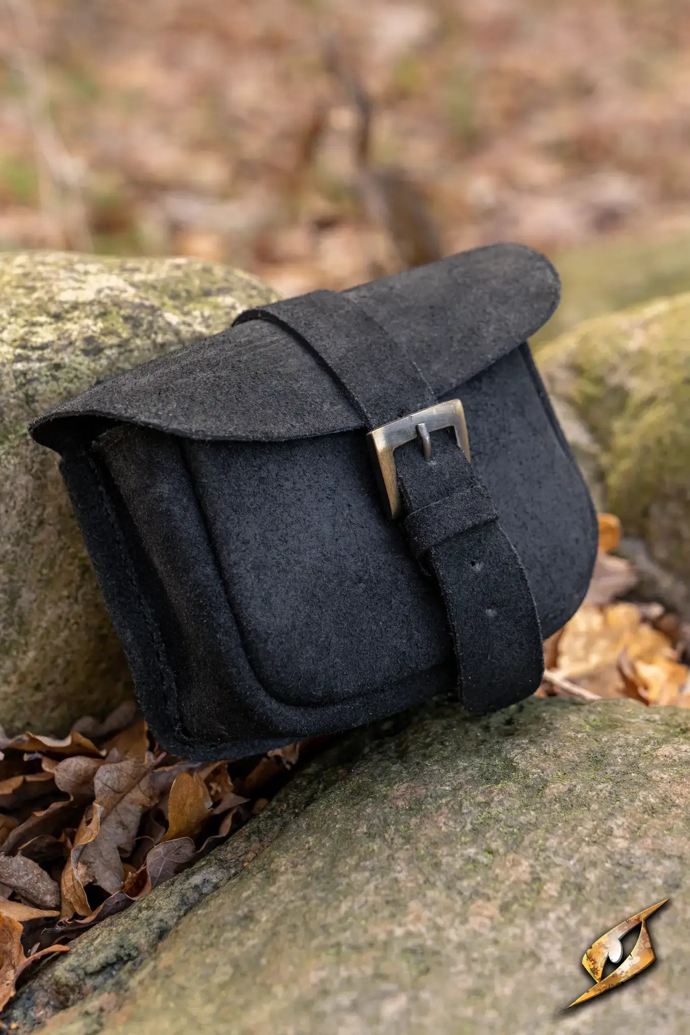 Warrior bag - Suede - Small resting on rocks surrounded by leaves, perfect for storing coins and small items.
