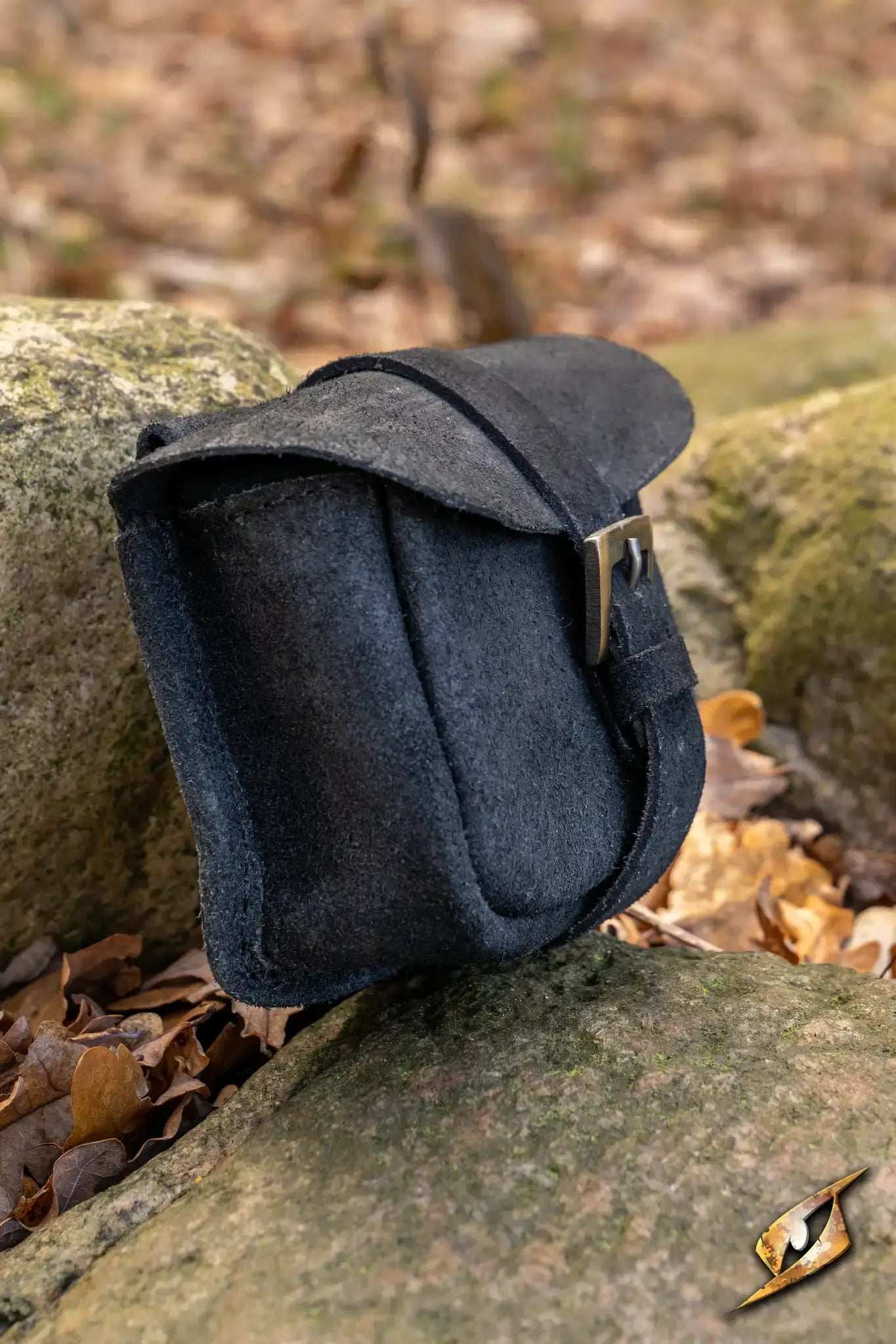 Warrior bag - Suede - Small on a stone surface, showcasing its durable suede material and practical design.