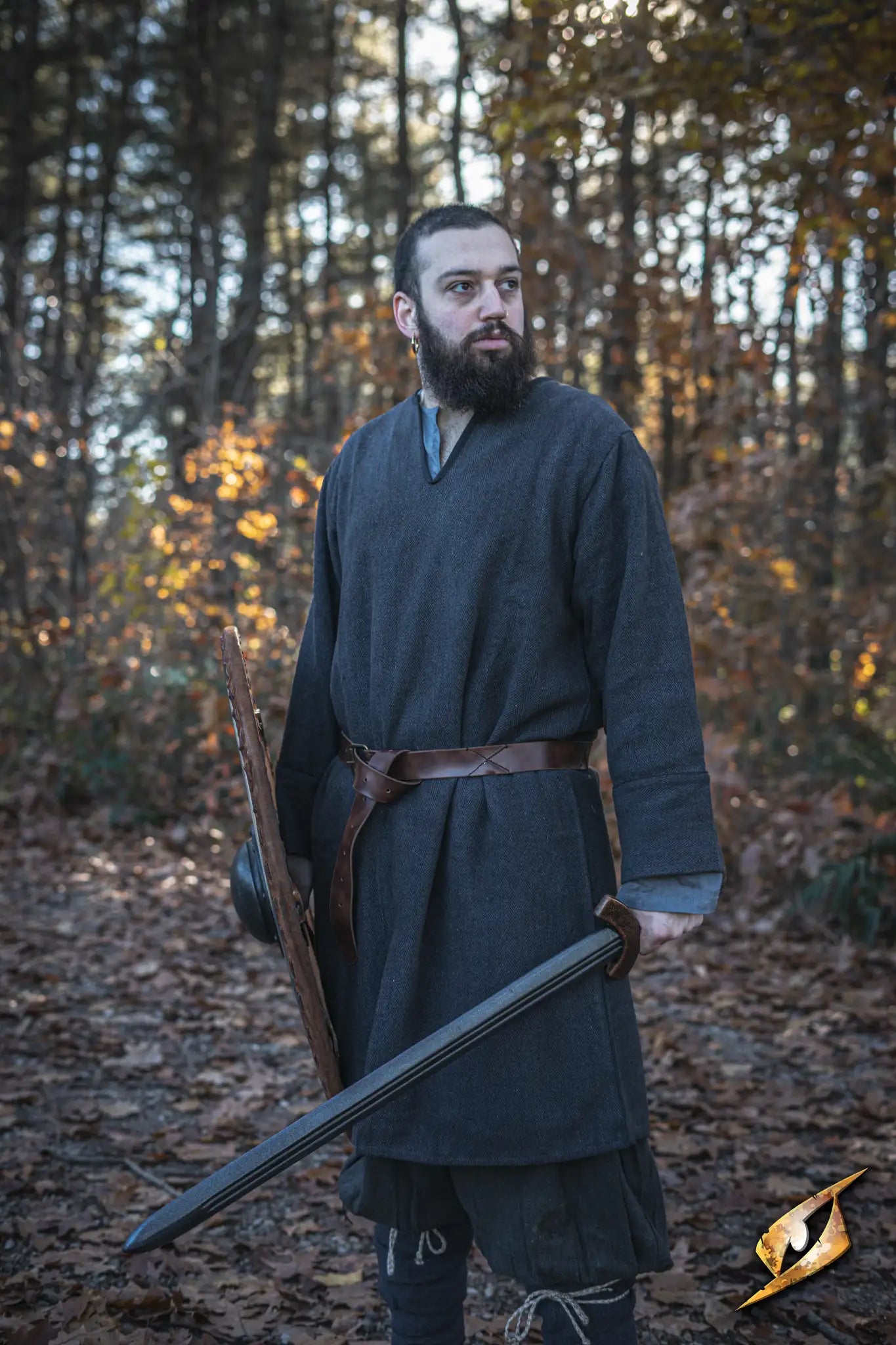 Warrior wearing an X Belt - Faux Leather, holding a sword and shield in a forest setting.