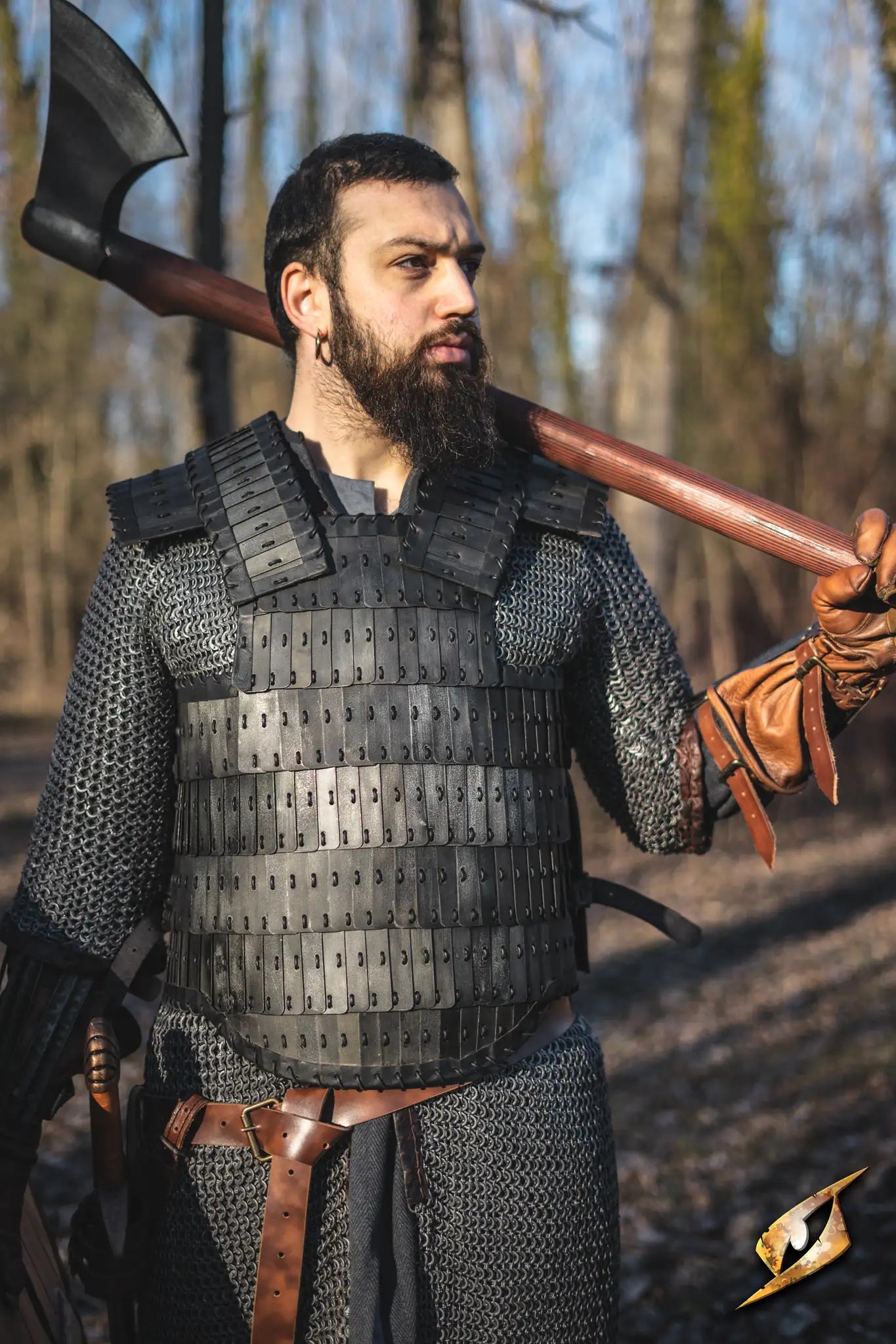 Warrior in chainmail armor holding a large axe, showcasing the X Belt - Faux Leather in a forest setting.