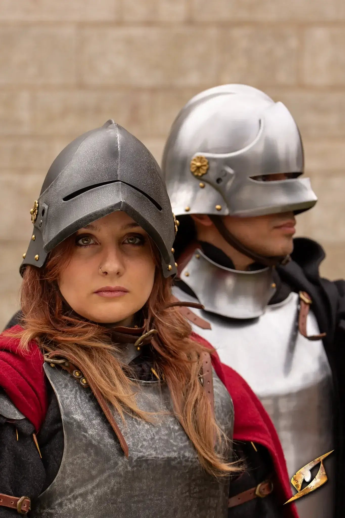 Two characters wearing medieval armor and helmets, showcasing the Renegade Helmet in a historical setting.