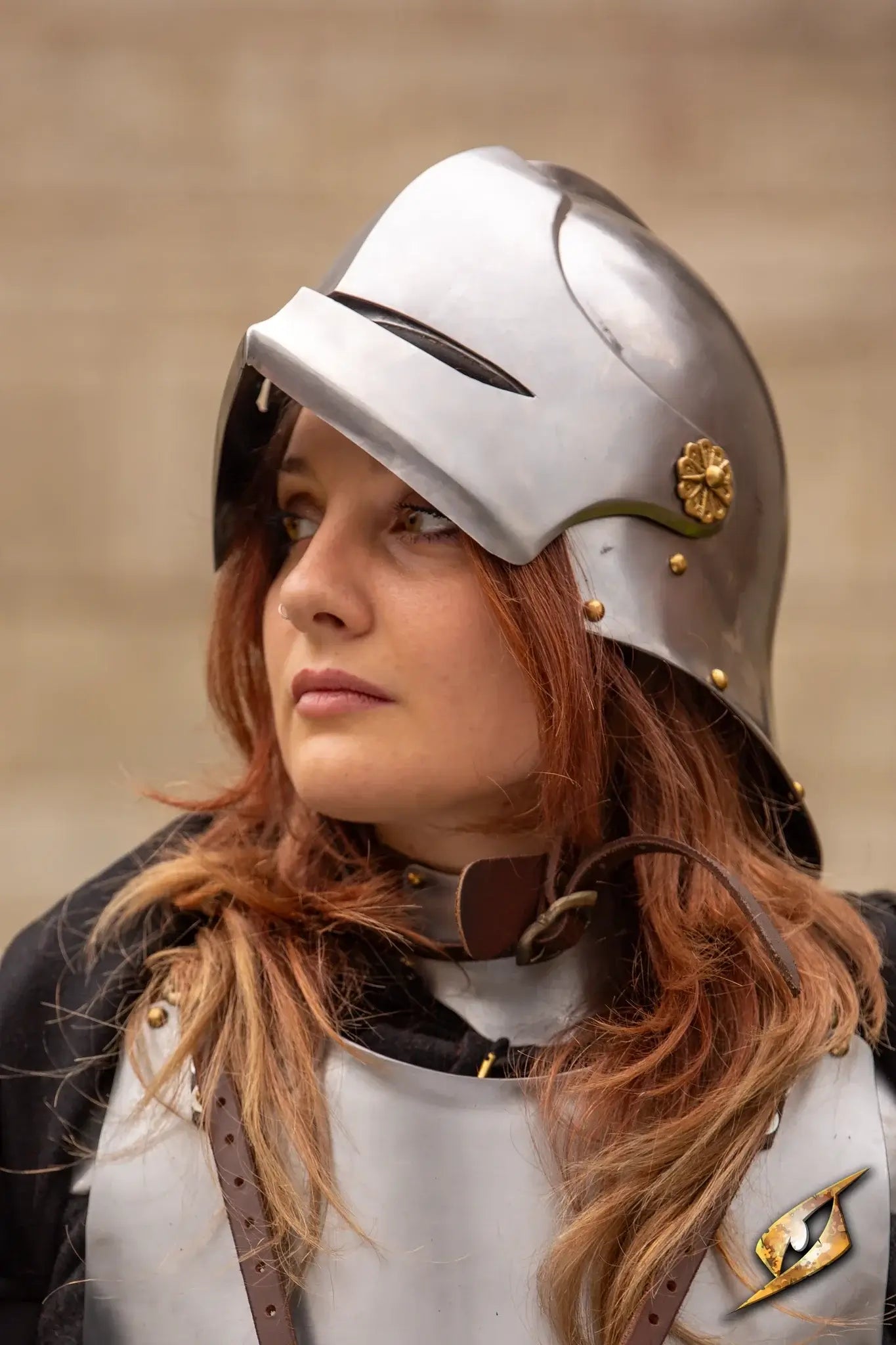 Renegade Helmet worn by a person with long brown hair, showcasing its sleek metallic design and historical detail.