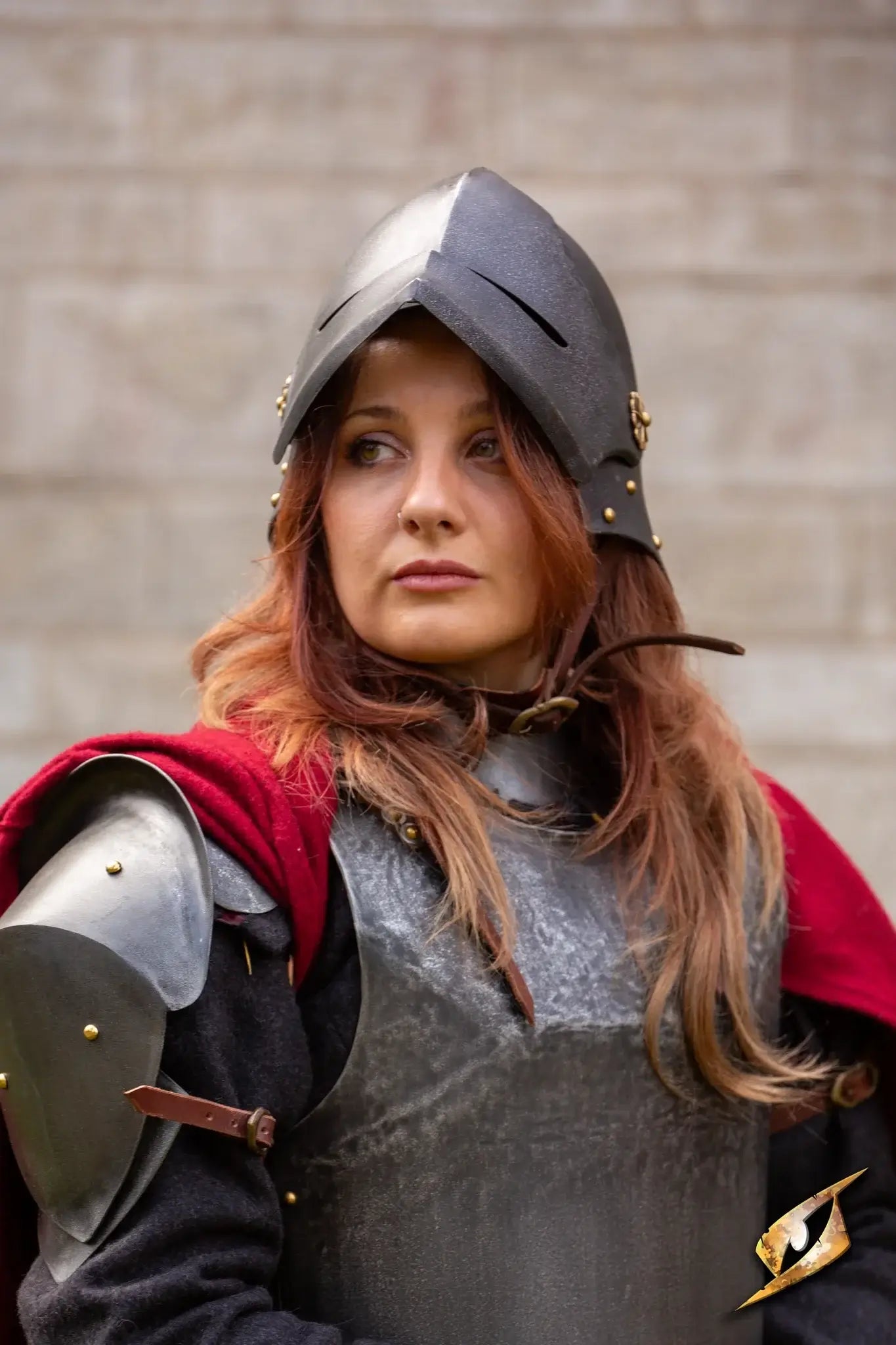 female warrior wearing a Renegade Helmet with armor and a red cape, ready for battle