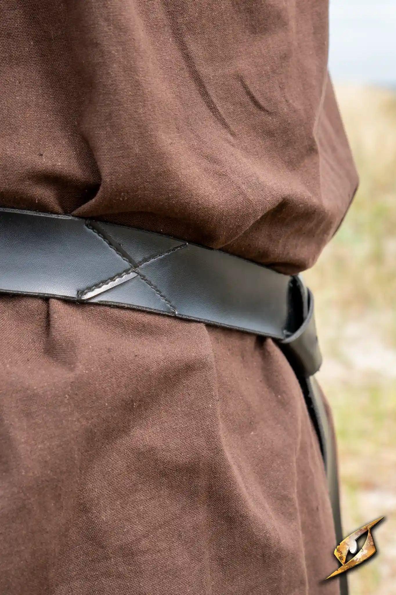 X Belt - Faux Leather shown worn over a brown garment, featuring a sleek design and detailed stitching.