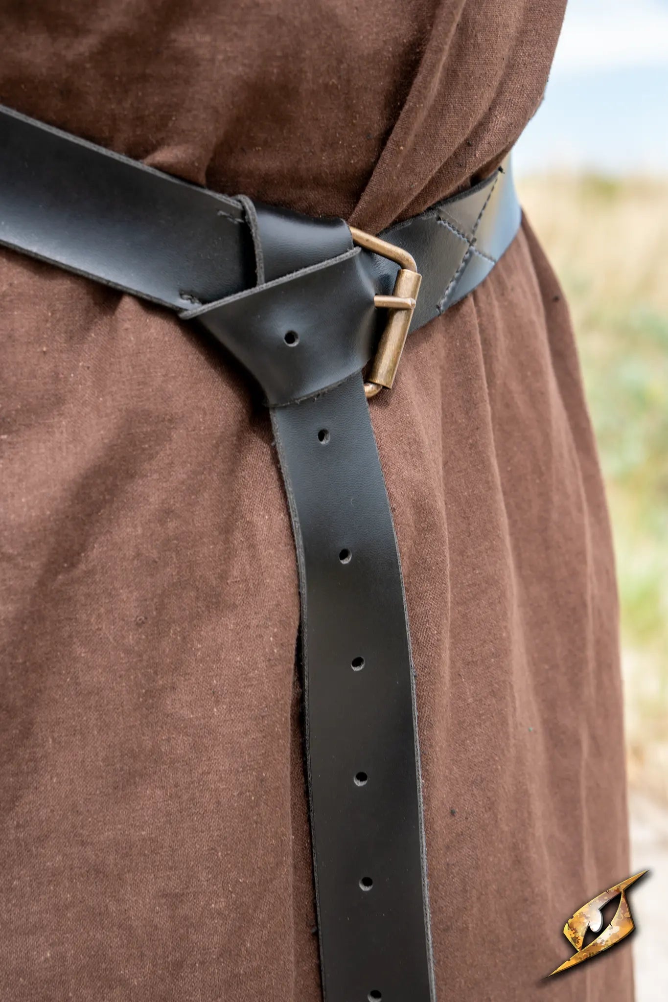 X Belt - Faux Leather worn with a brown garment, showcasing its sleek design and adjustable fit.