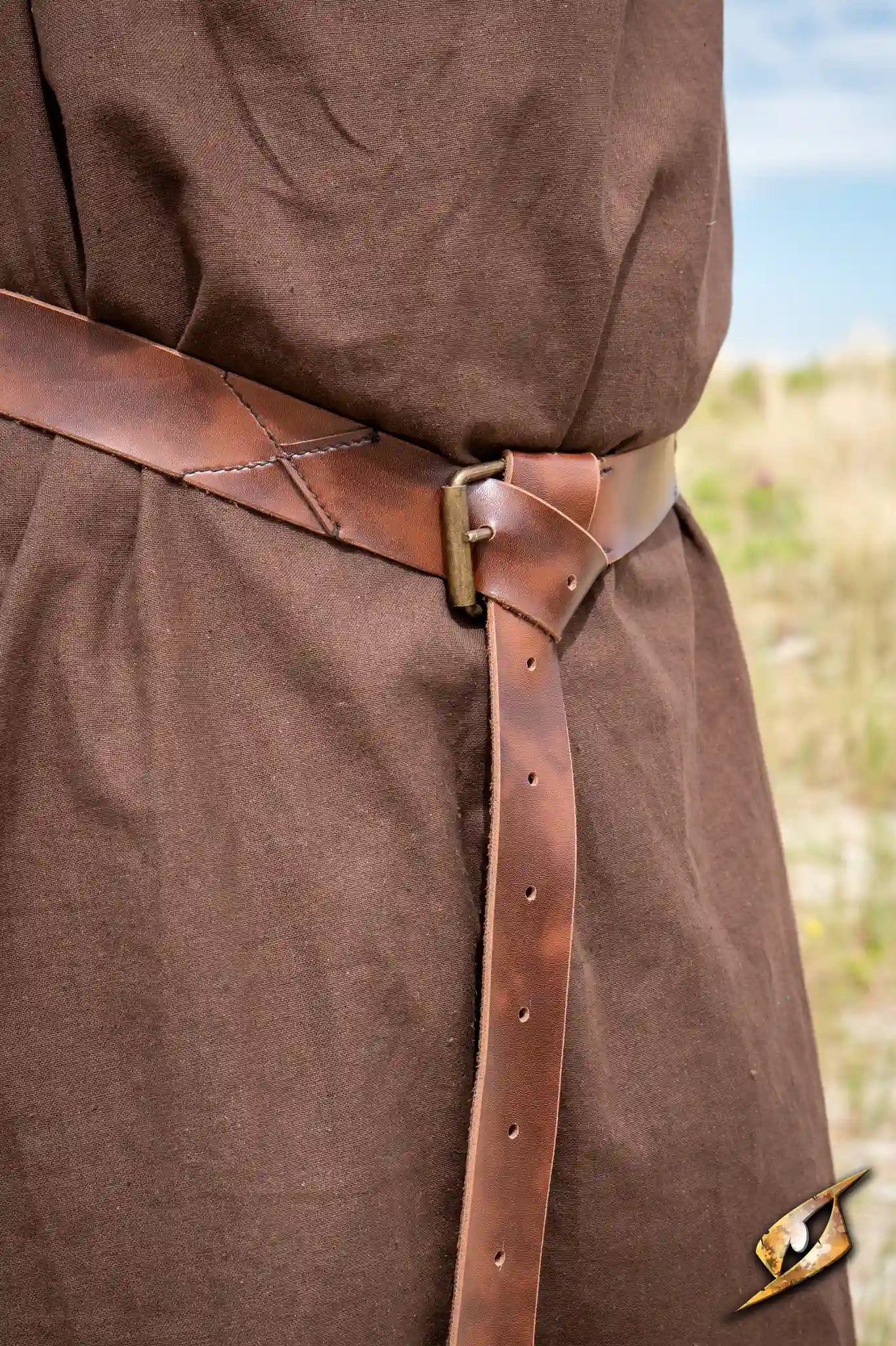 X Belt - Faux Leather worn with a brown garment outdoors, showcasing its design and craftsmanship.