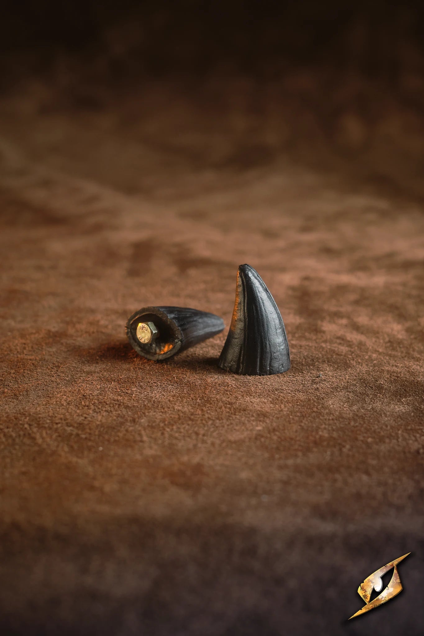 Mountable Demon Horns displayed on a brown surface, featuring a pair of stylish, black spikes for armor decoration.