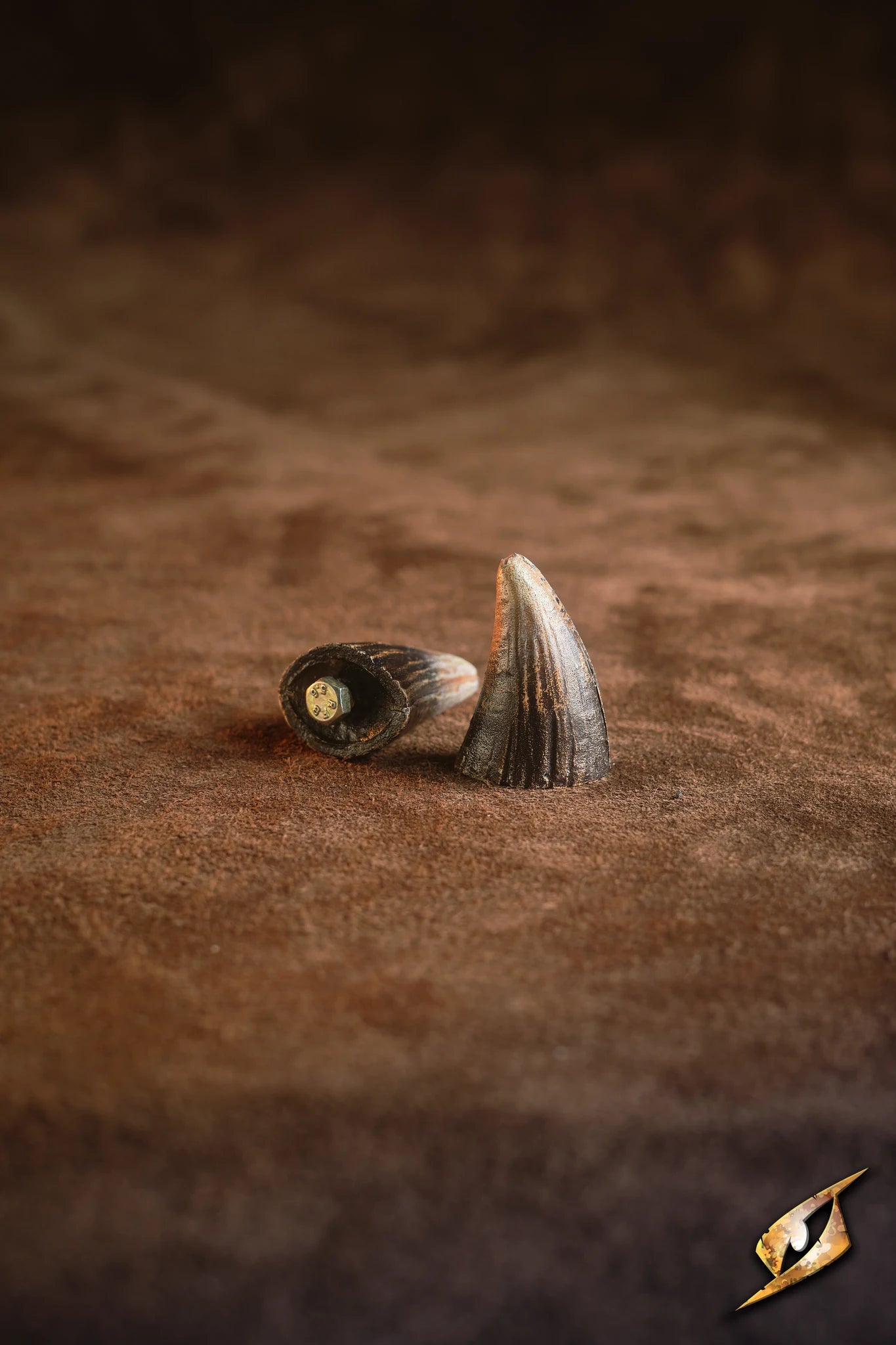 Mountable Demon Horns displayed on brown fabric, perfect for enhancing monstrous armor looks.
