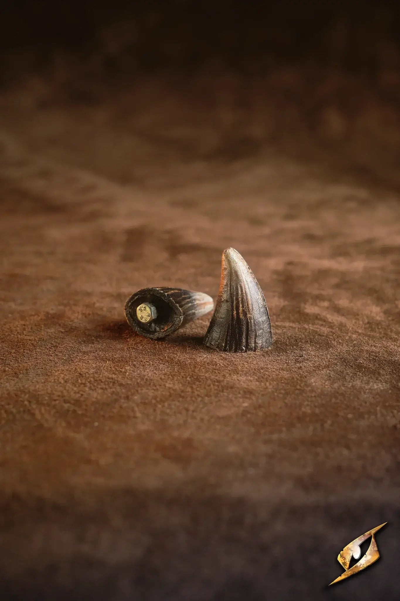 Mountable Demon Horns displayed on brown fabric, perfect for enhancing monstrous armor looks.