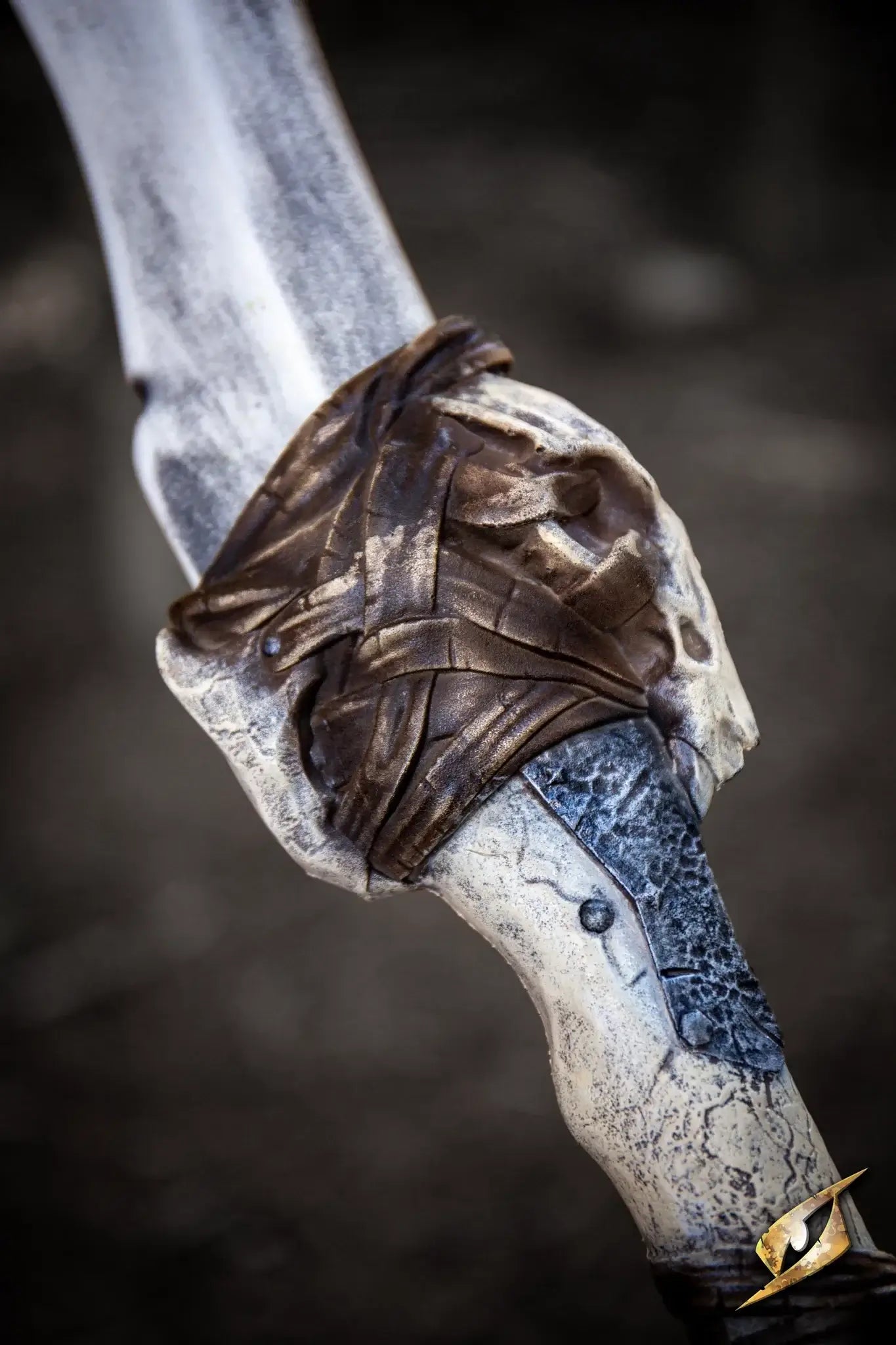 Close-up of the handle of the Bone Chopper - 100 cm. sword, featuring intricate designs and tribal elements.