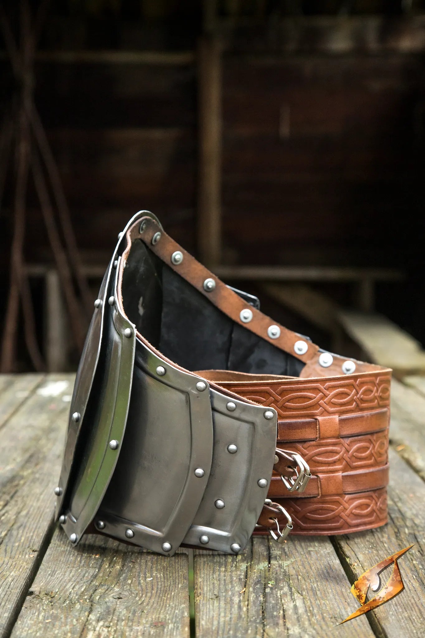 Gut plate from the side showing both polished steel and leather belting