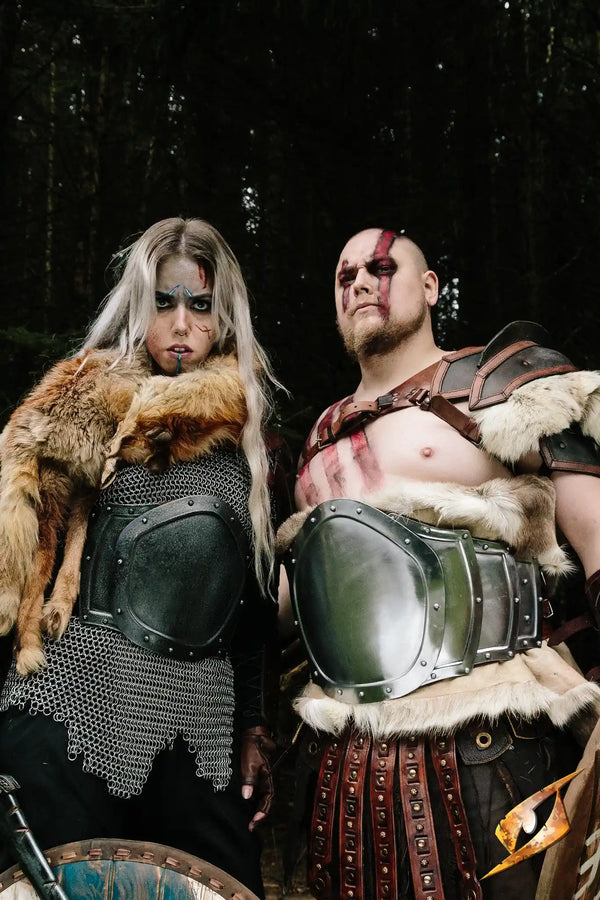 2 human barbarians wearing a gut plate