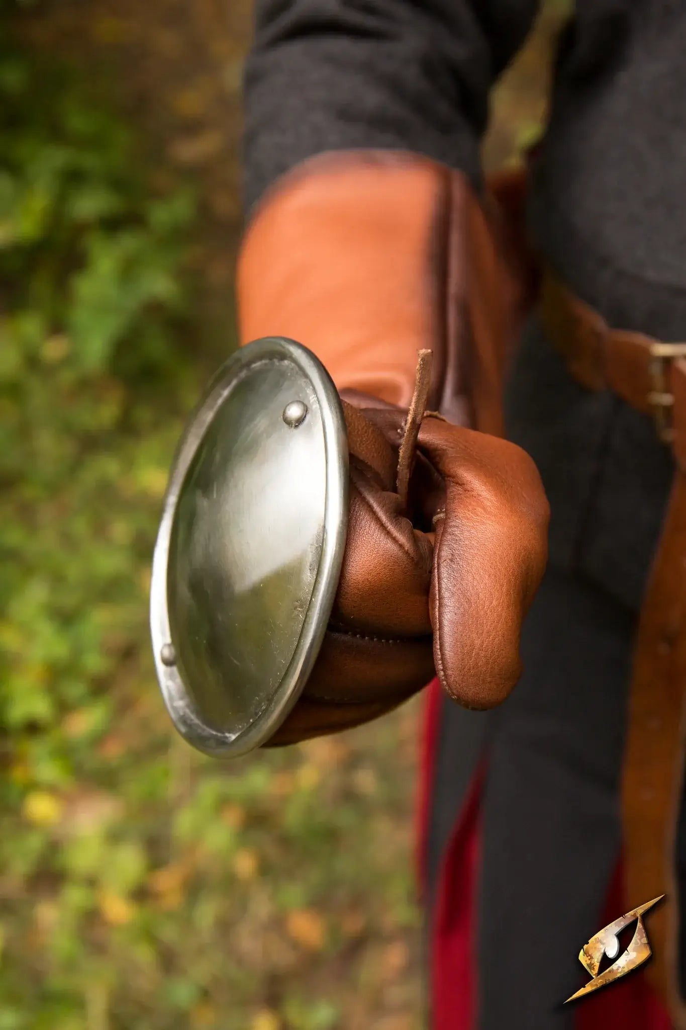 A close-up of a hand wearing Rondel Hand Protection, showcasing the protective handguard and leather gloves.