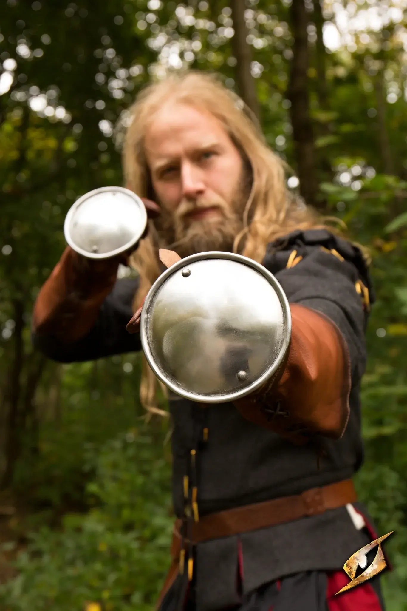 Fencer demonstrating Rondel Hand Protection with metal guards in an outdoor setting.