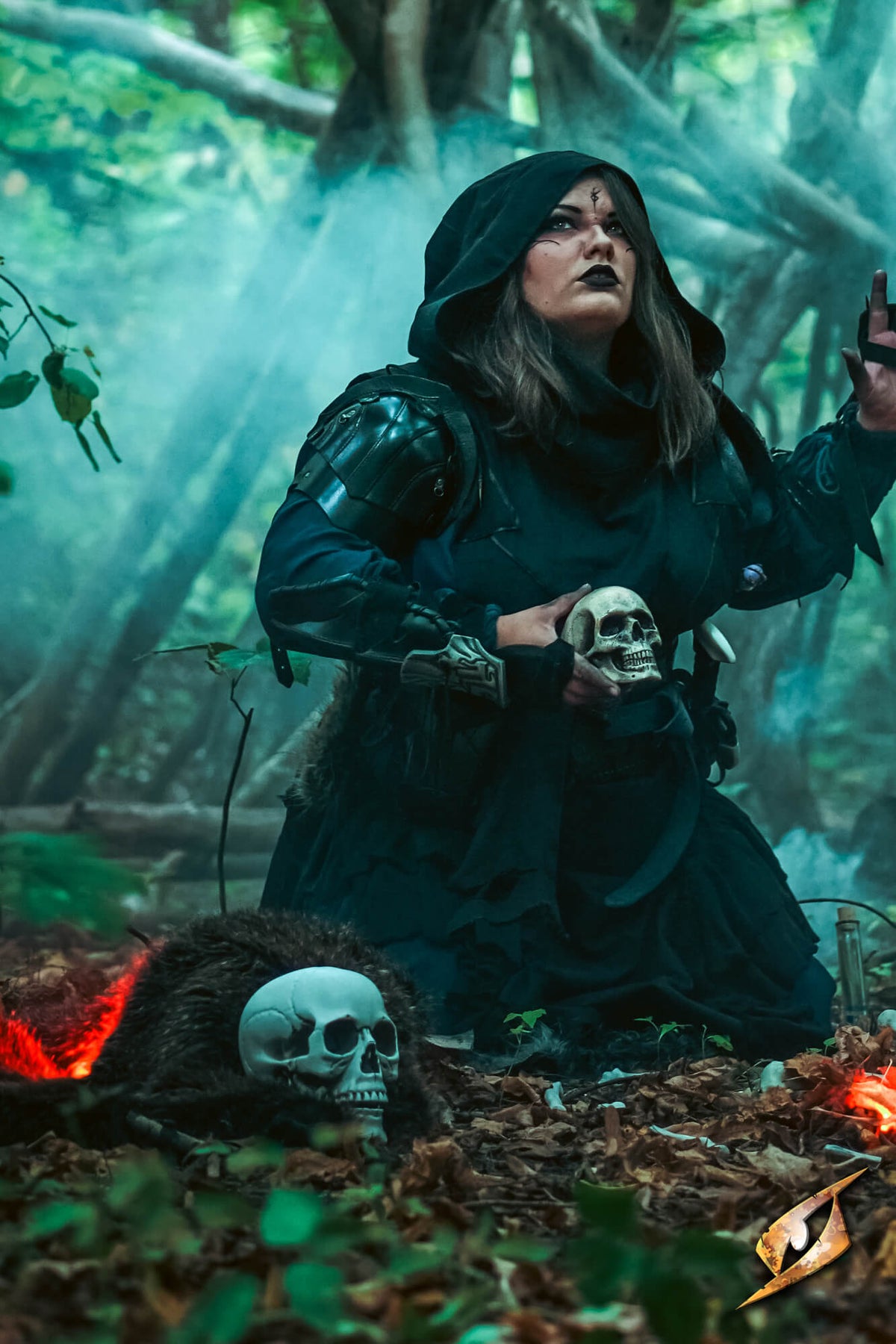 Woman dressed as fantasy sorceress performing rituals in a forest clearing