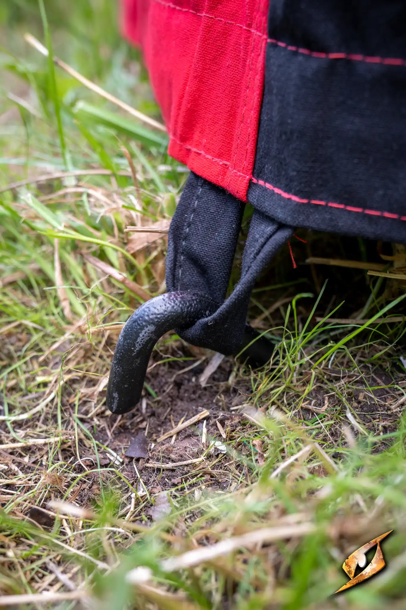 Close-up of a Marquee Tent - 4x4m stake securing the tent in grass.