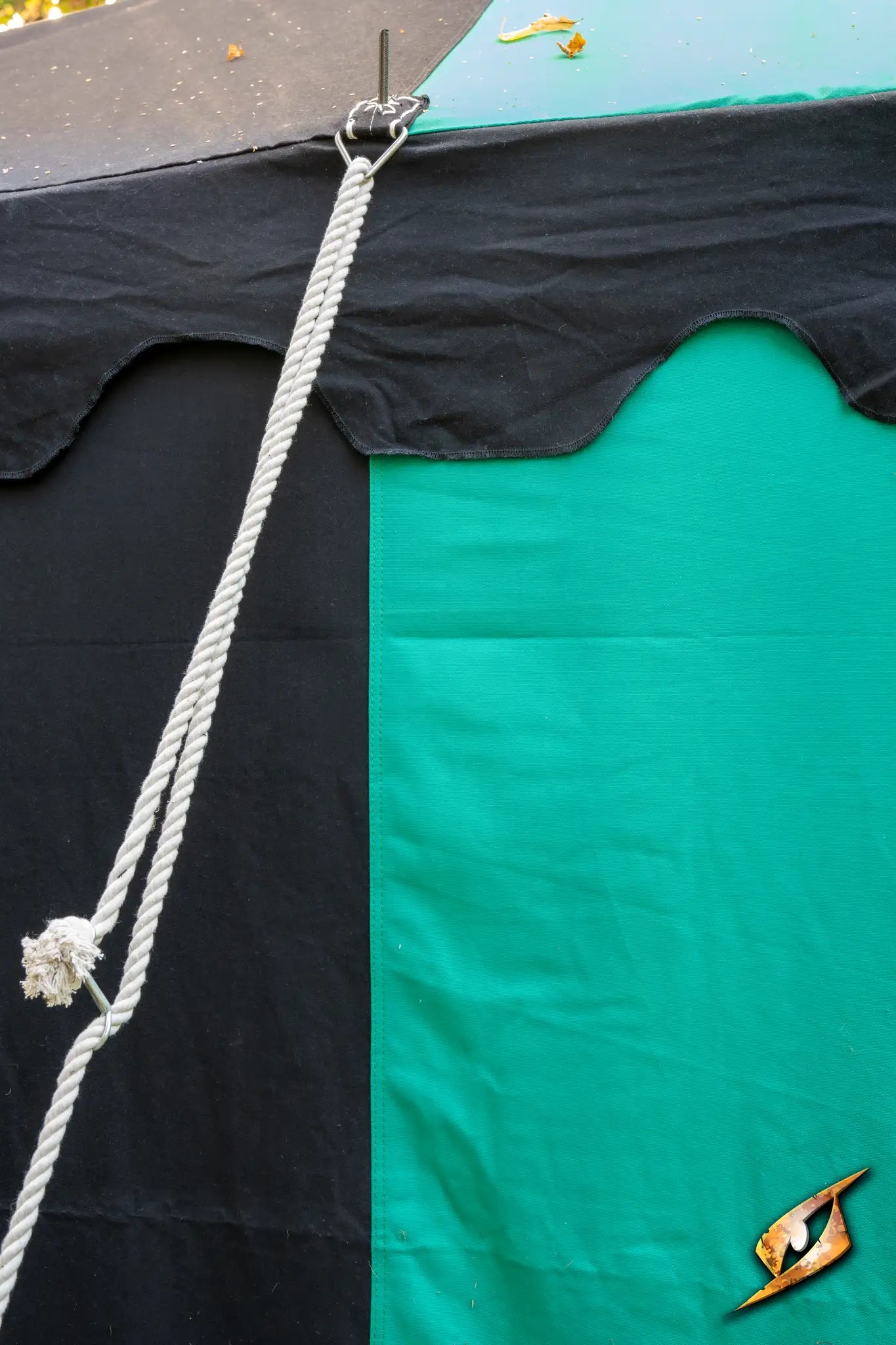 Marquee Tent - 4x4m close-up showing black and green fabric with rope and hook details.