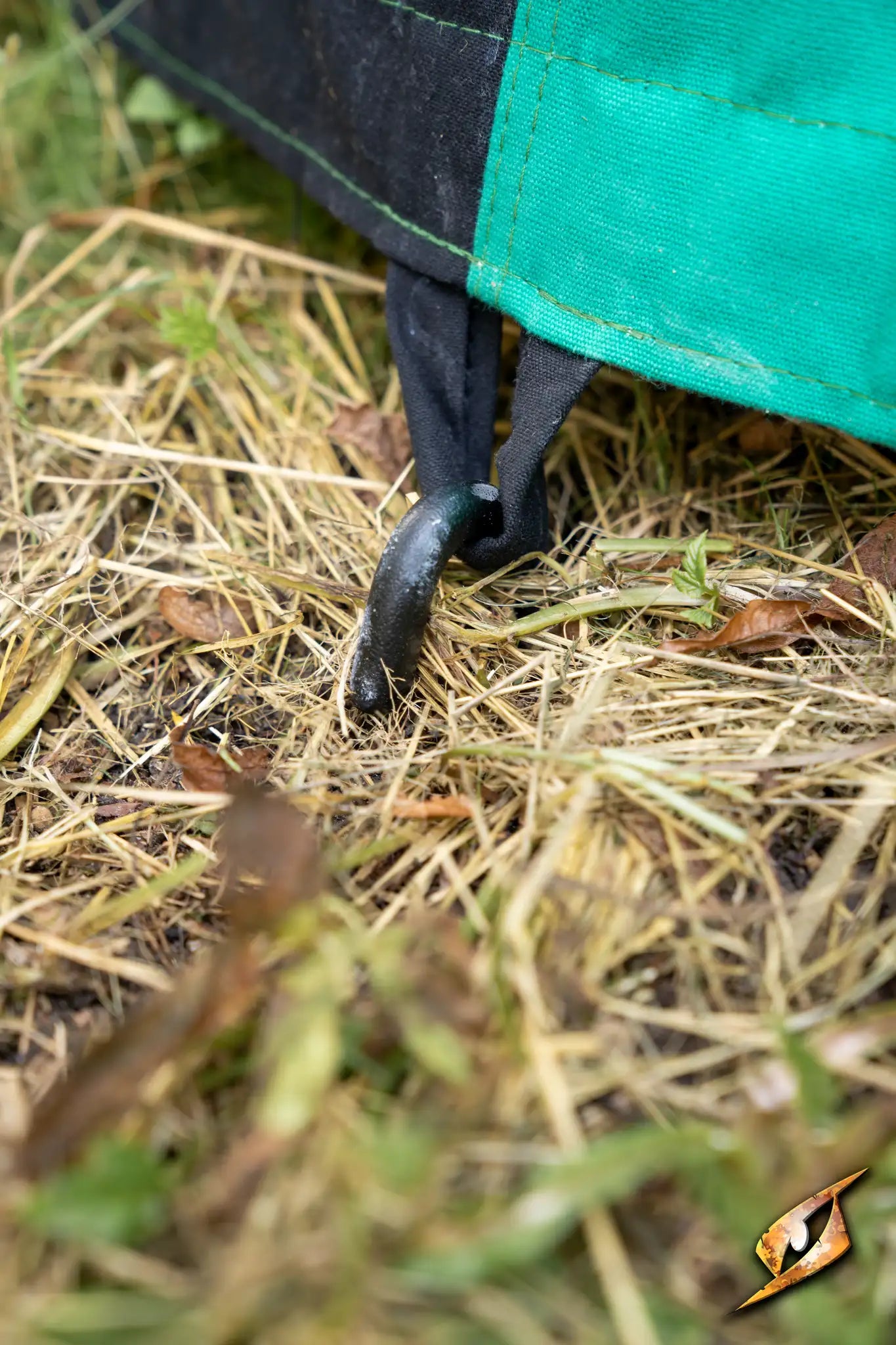 Close-up of a stake securing the Marquee Tent - 4x4m to the ground, showcasing stability and outdoor use.
