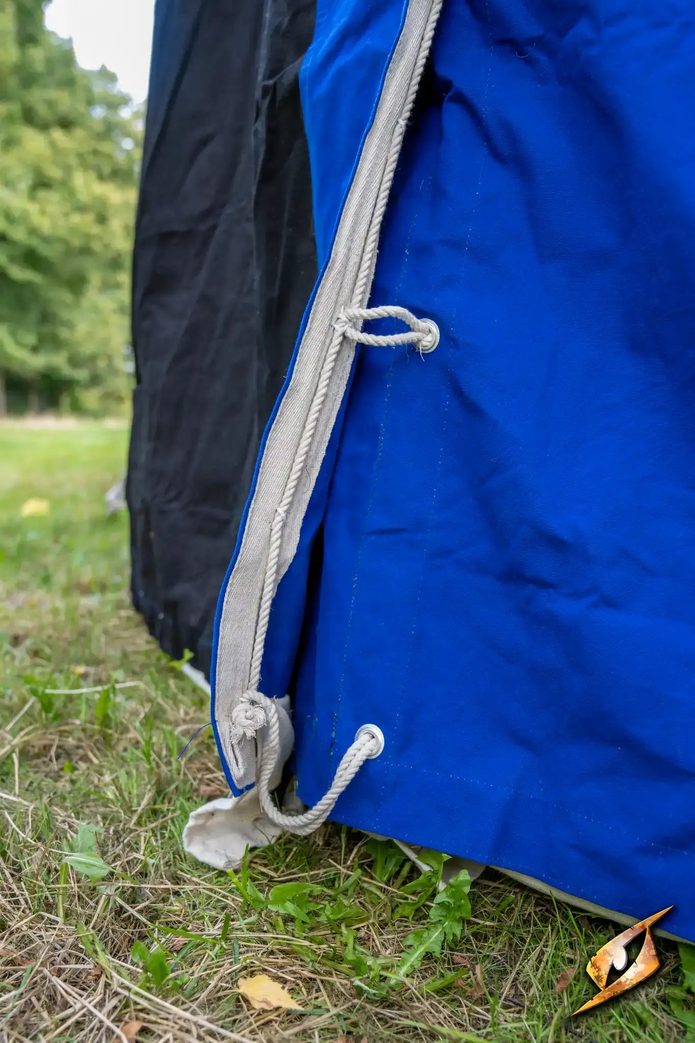 Close-up of the Marquee Tent - 4x6m showing blue fabric and rope ties on the side.