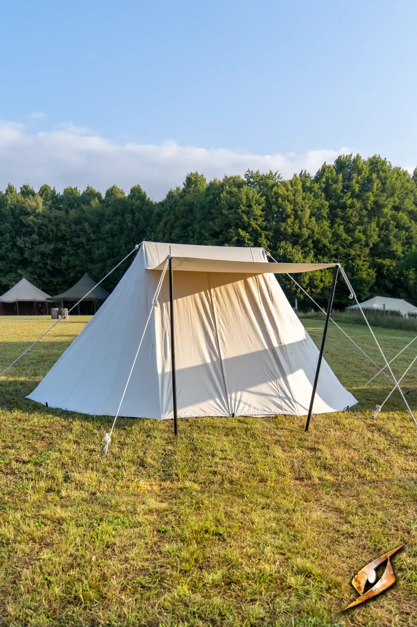 Double Wedge Tent - 3x5 m set up in a grassy field with trees in the background.