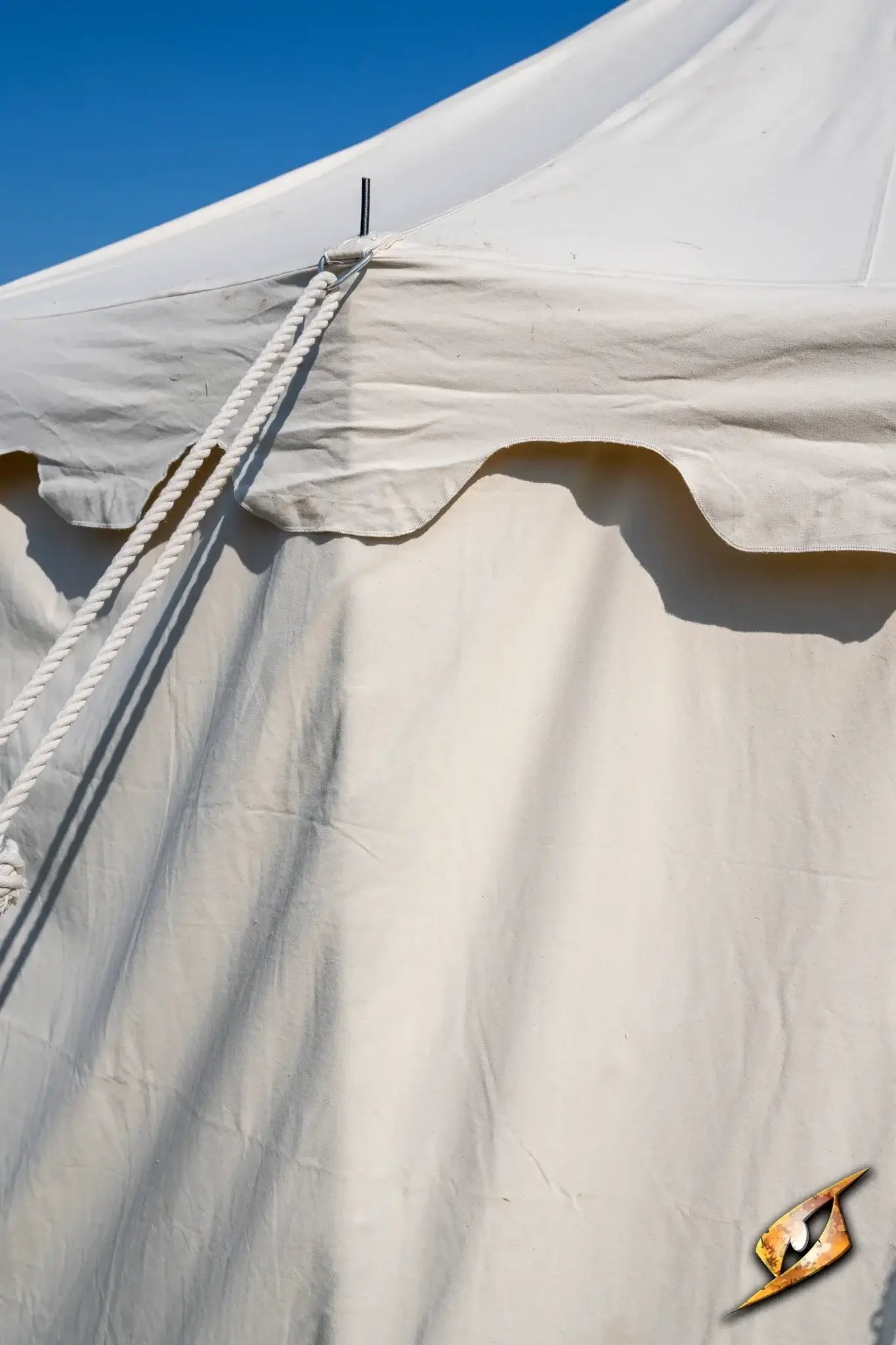 Round Pavilion Tent - 5 m with off-white fabric and ropes against a clear blue sky.