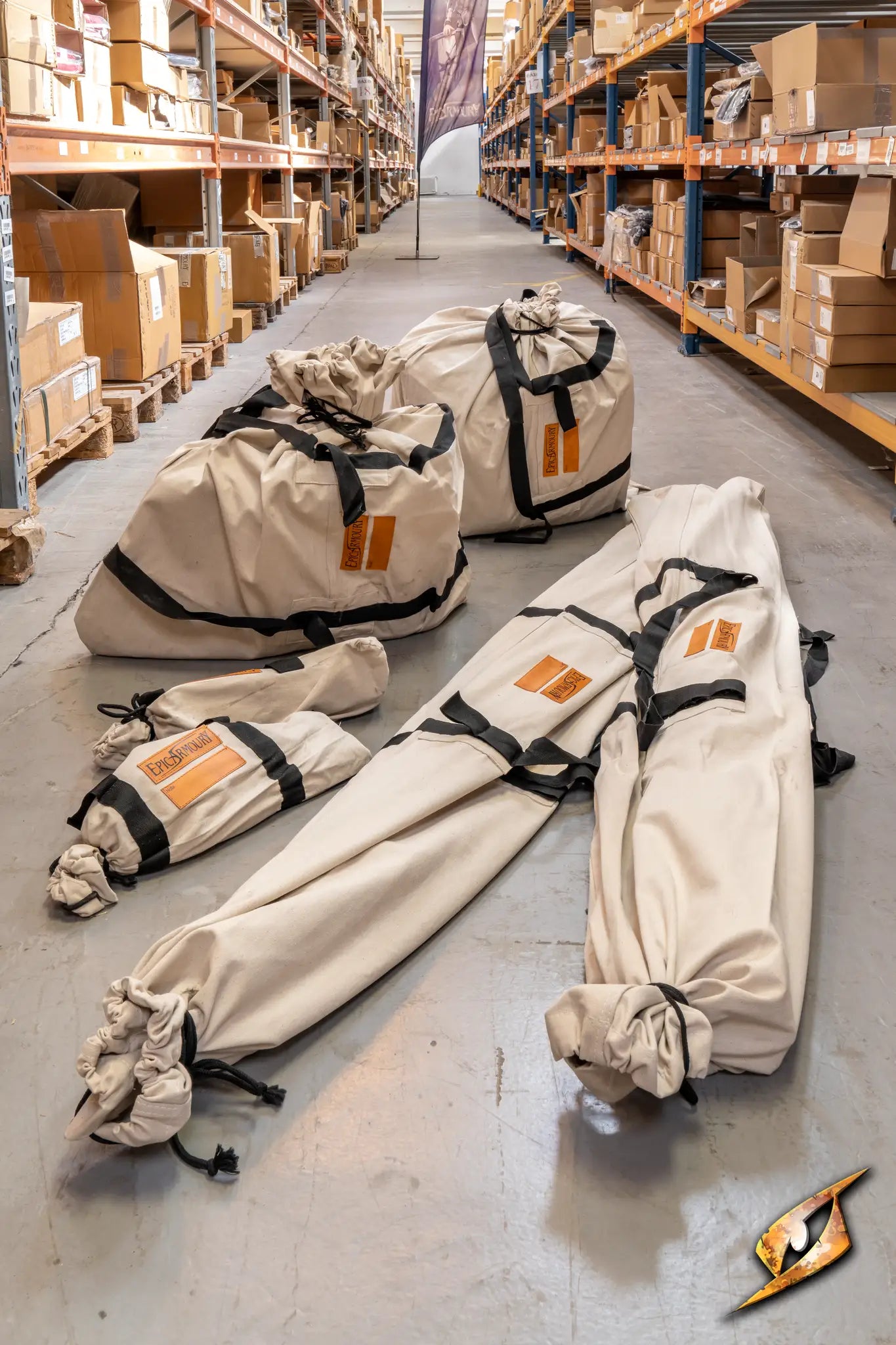 Round Pavilion Tent - 5 m storage bags in a warehouse aisle with cardboard boxes.